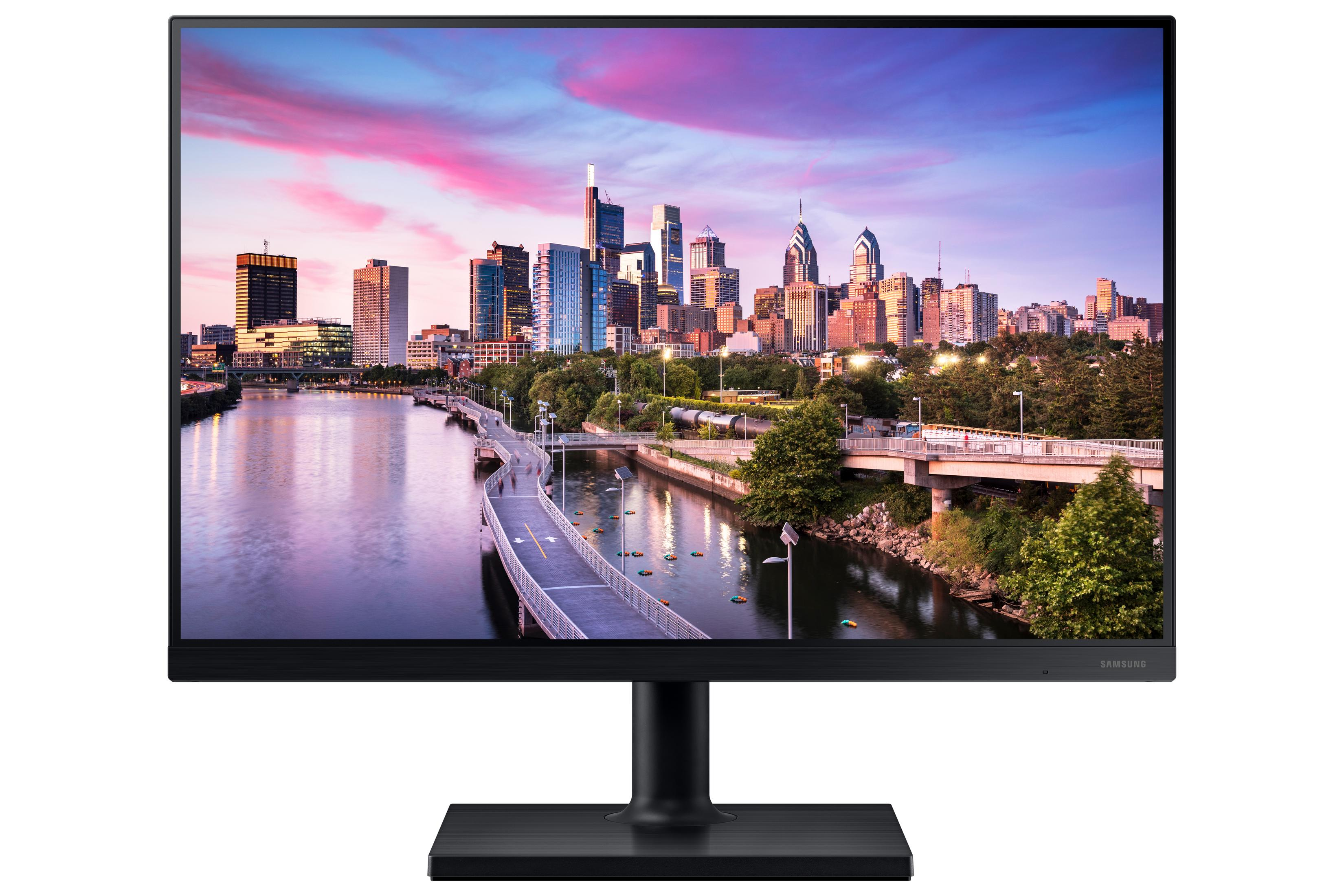 Un monitor de computadora muestra el horizonte de una ciudad sobre agua al atardecer. Base y marco negros.