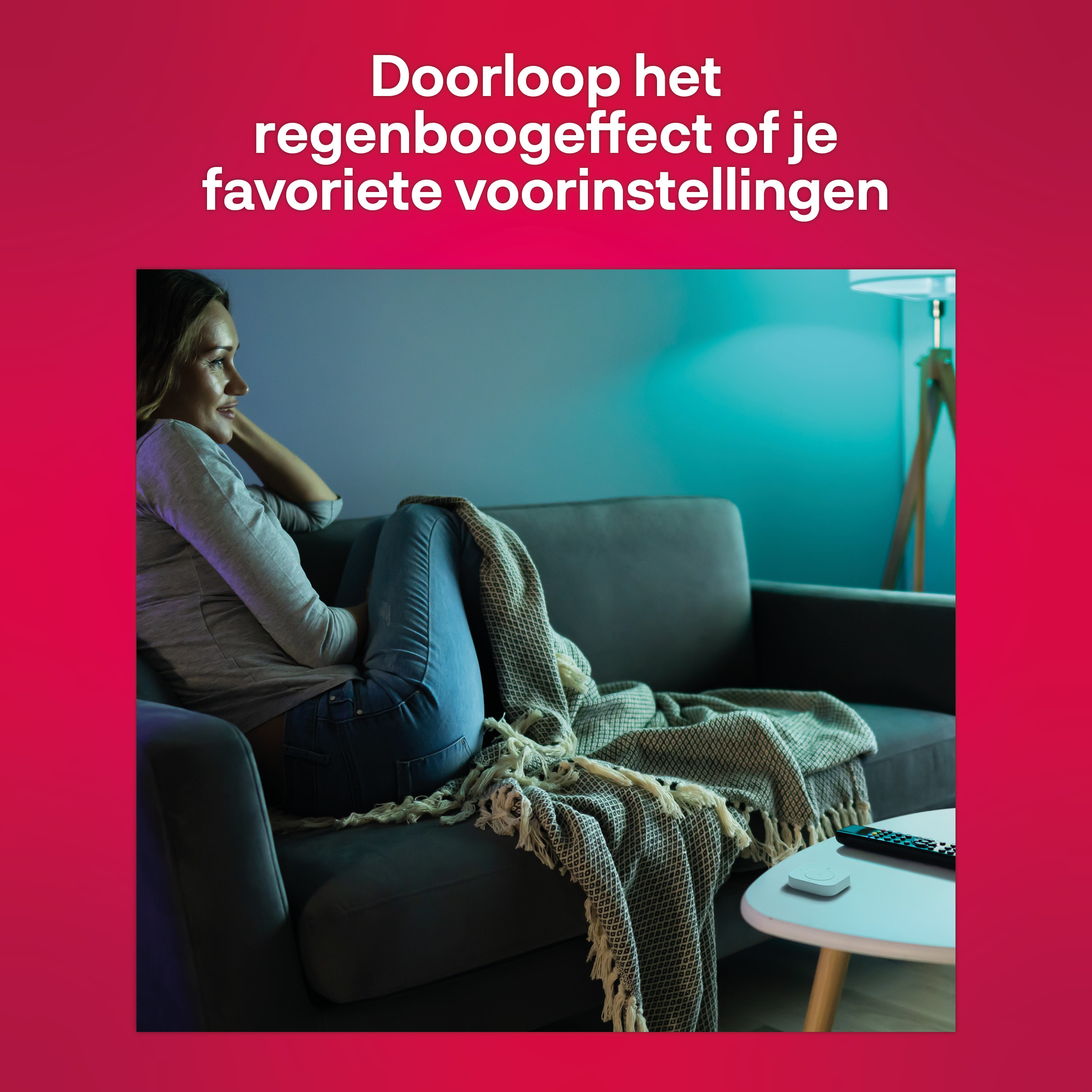 Woman on couch with blanket, watching a TV.