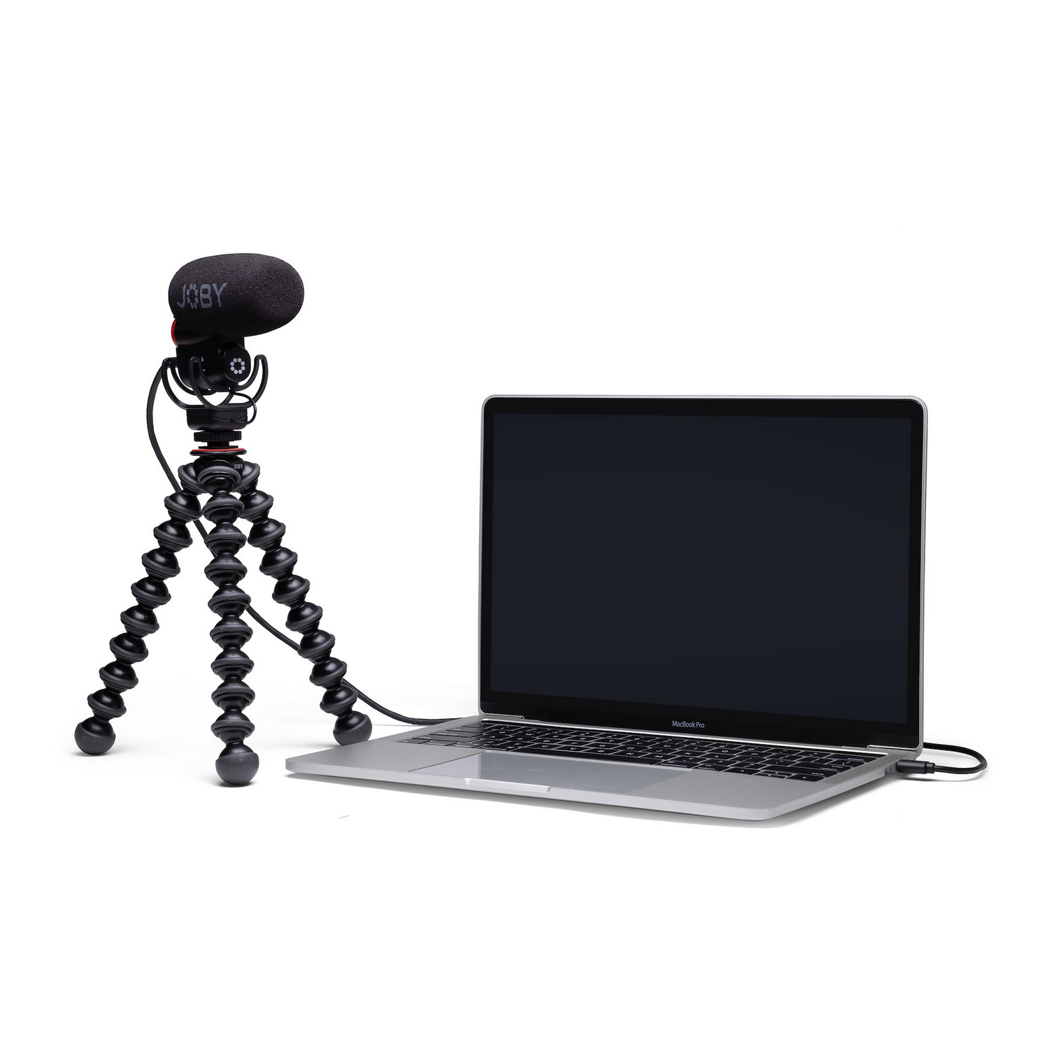 Microphone on a tripod next to a laptop. The laptop screen is black.