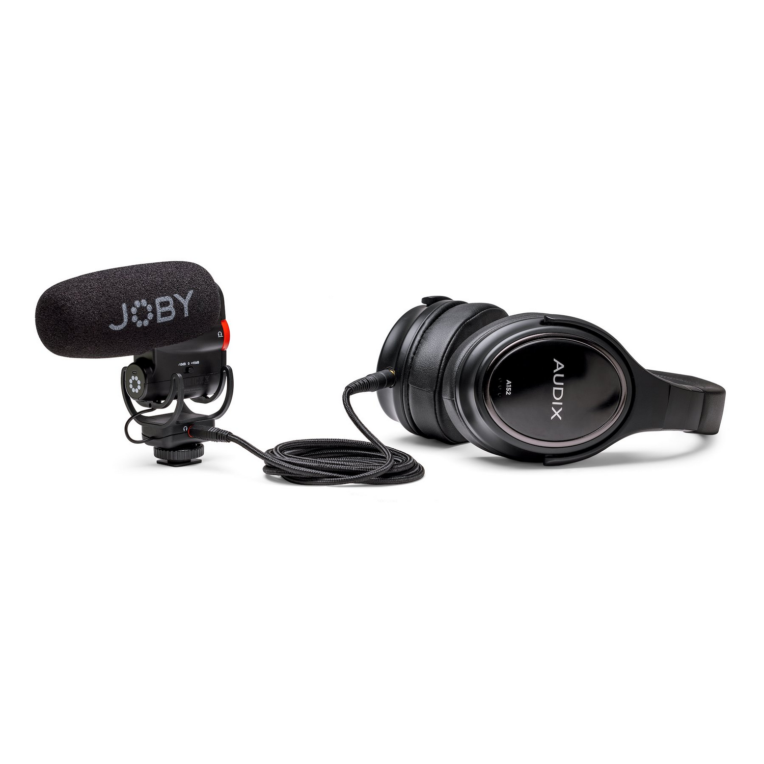 Microphone and headphones on a white background. The microphone has a cover.