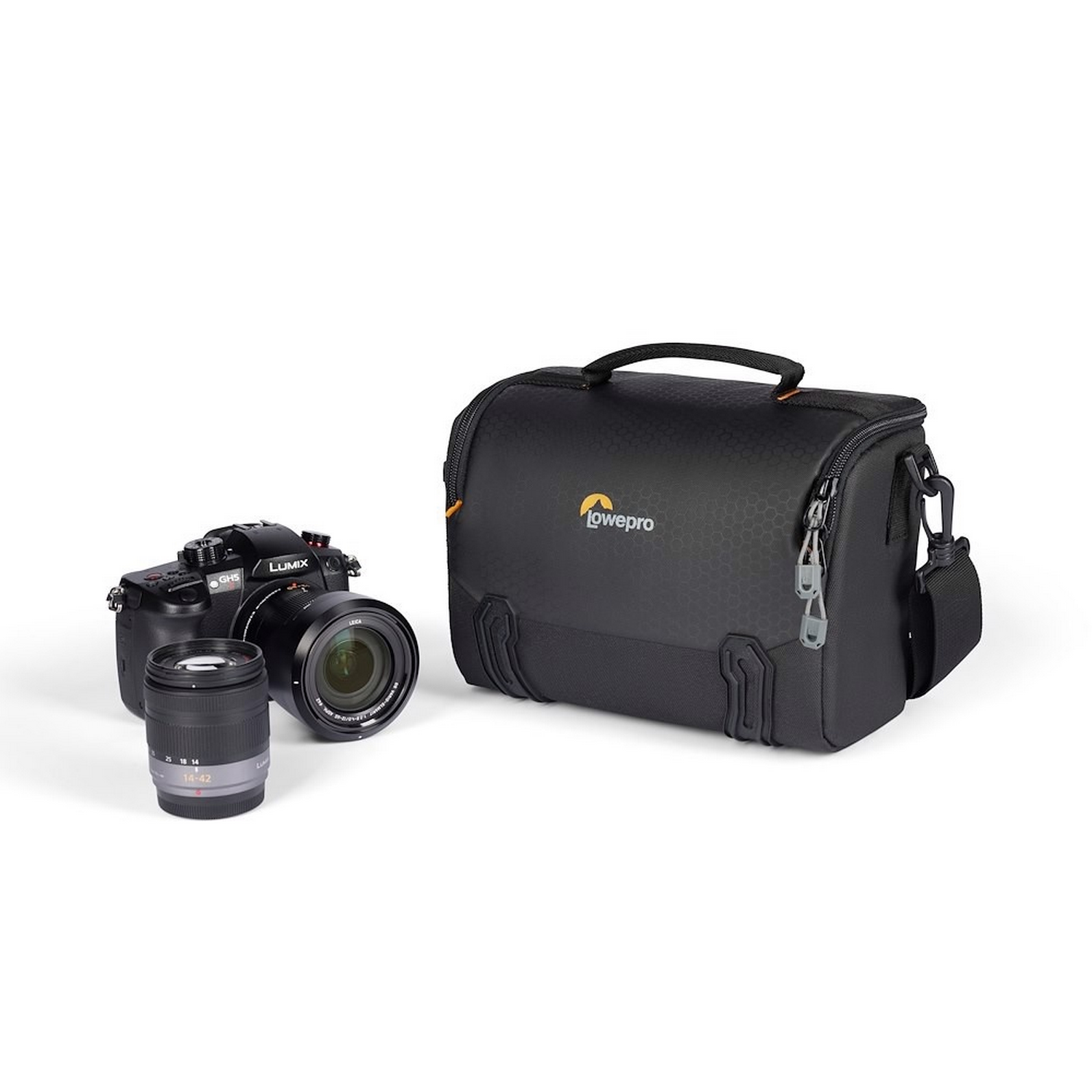 A camera, lens, and a black camera bag. The bag has a handle and the Lowepro logo.