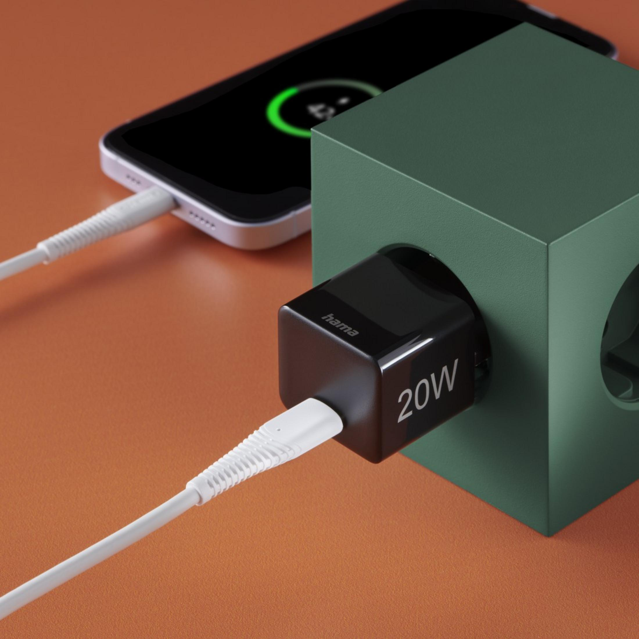 Czarna ładowarka Hama z telefonem i zieloną kostką. Pomarańczowe tło.