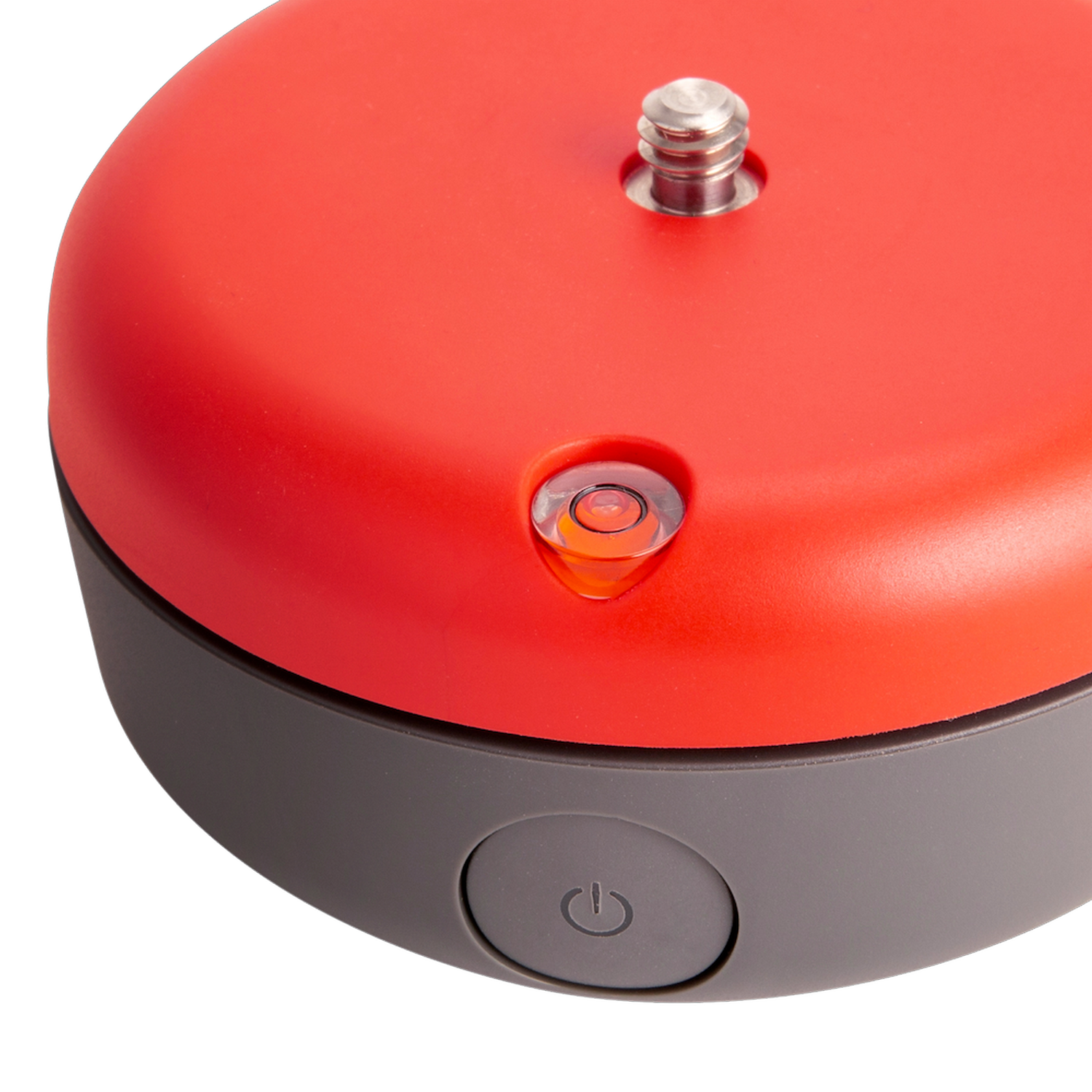 Een rood en grijs apparaat met een waterpas en een aan/uit-knop. Het is rond.