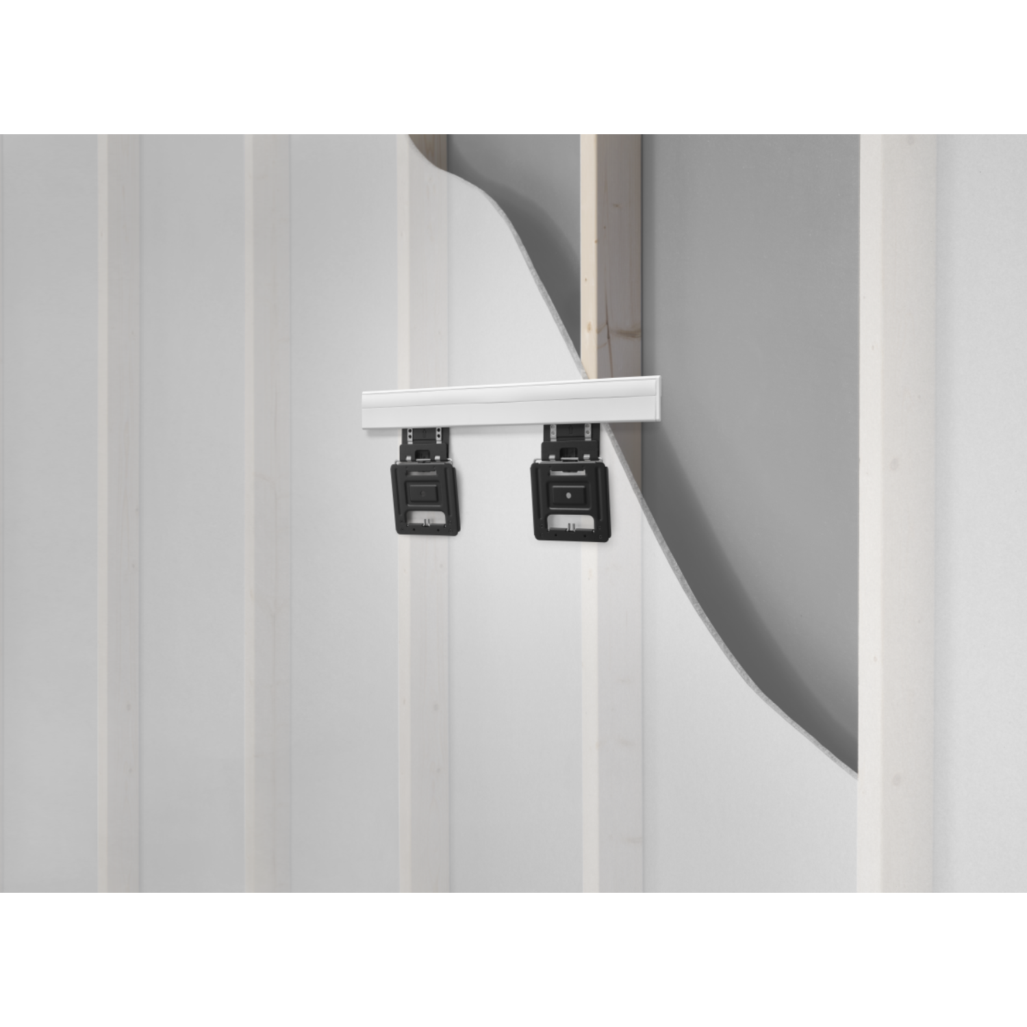 Two black boxes attached to a white wall. The boxes are mounted on a white bar.