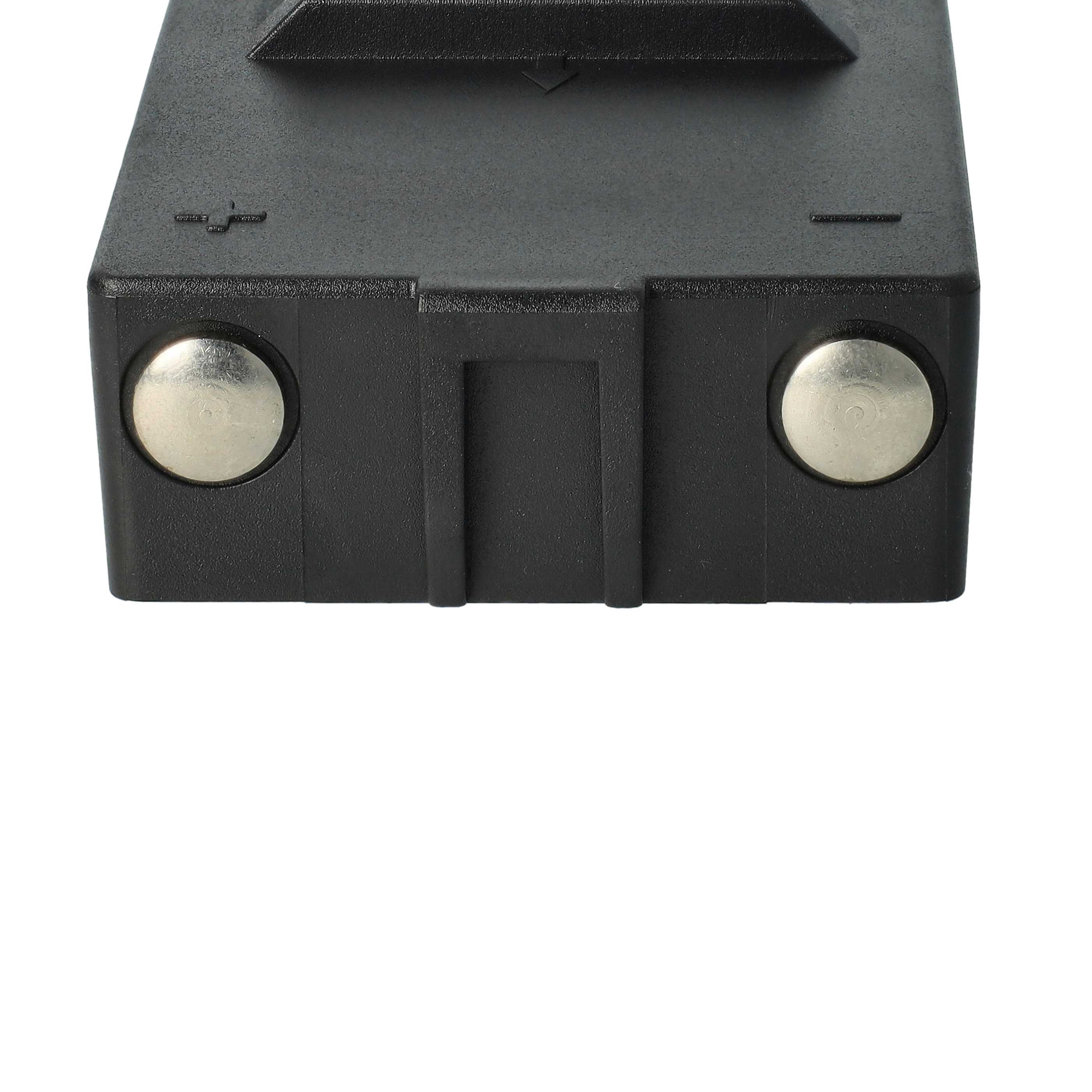 Ein schwarzes elektronisches Bauteil mit zwei silbernen Kreisen und einem Minus/Plus-Zeichen.