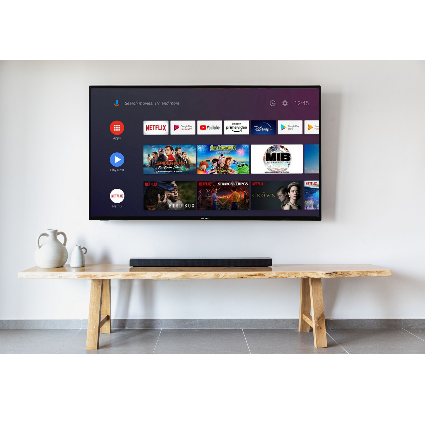 A TV displaying streaming apps over a wooden table. A soundbar rests below the screen.