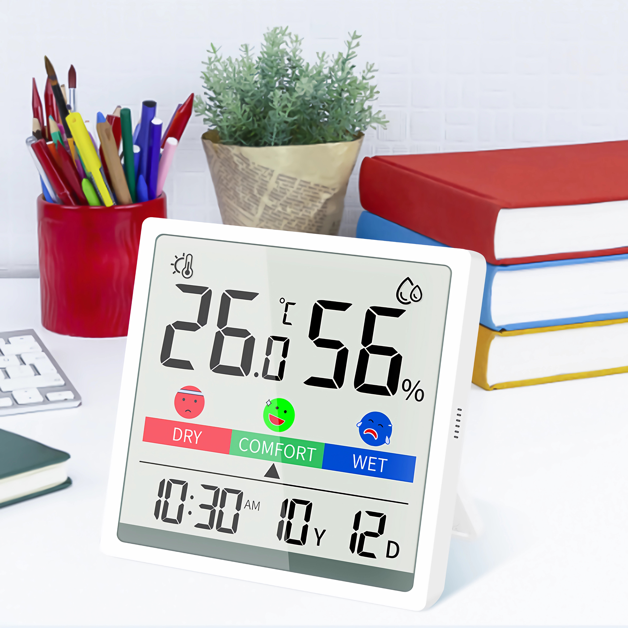 Digitales Thermometer mit 26,0°C, 56% und der Uhrzeit 10:30 Uhr. Symbole für trocken, Komfort, feucht.