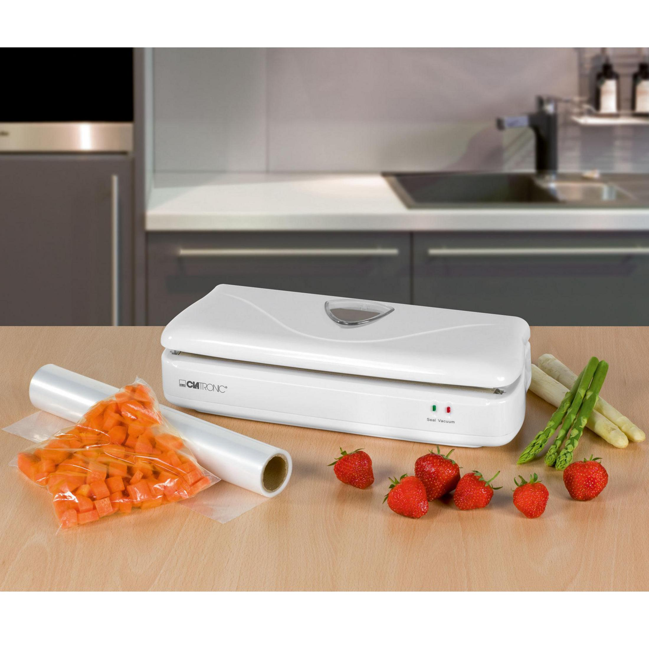 Biała zgrzewarka do żywności z warzywami i truskawkami na drewnianej powierzchni.