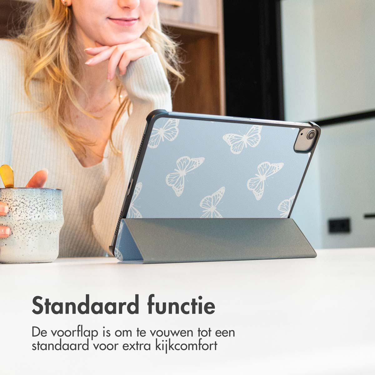 Woman with a butterfly design tablet. It is in a stand position.