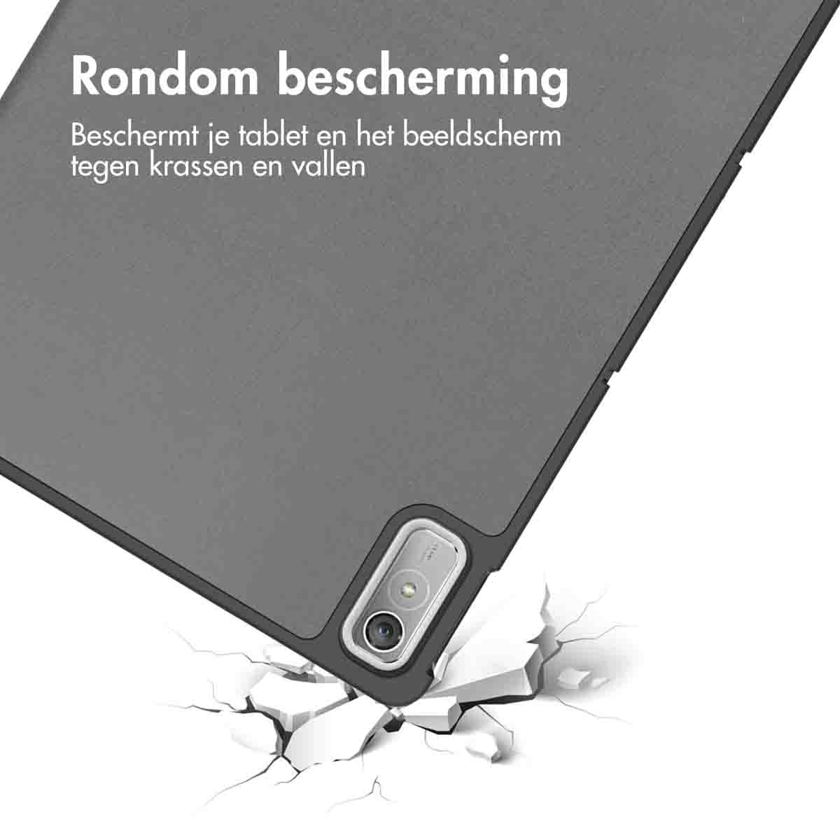 A gray tablet in a case, with text about protection, falling onto a cracked surface.