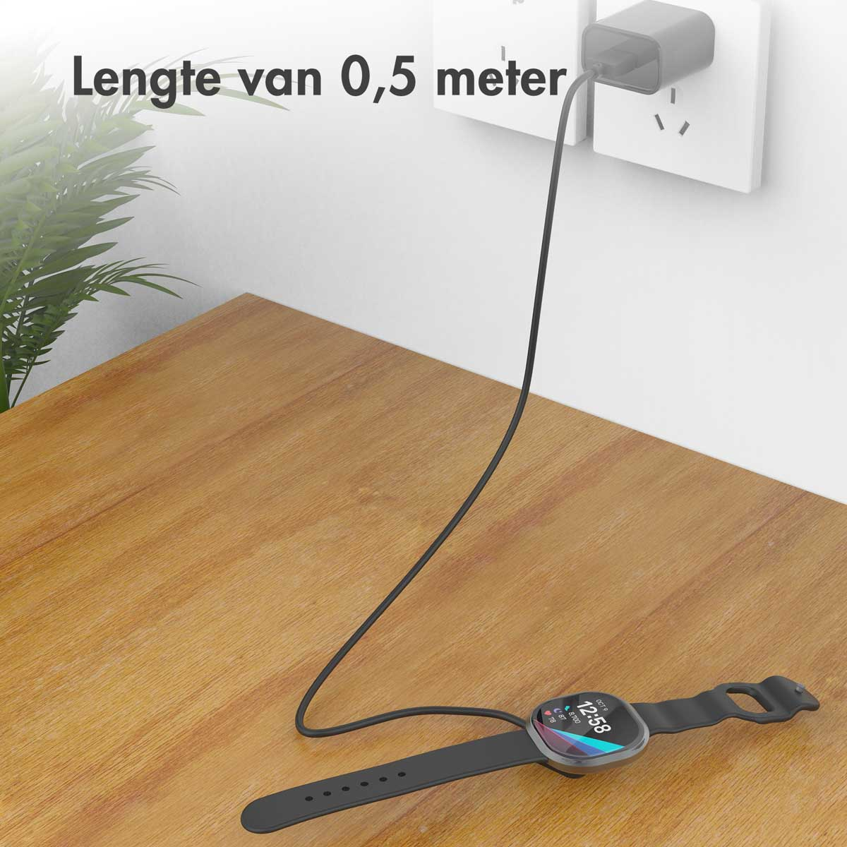 Smartwatch en charge sur une table en bois, connectée à une prise murale.