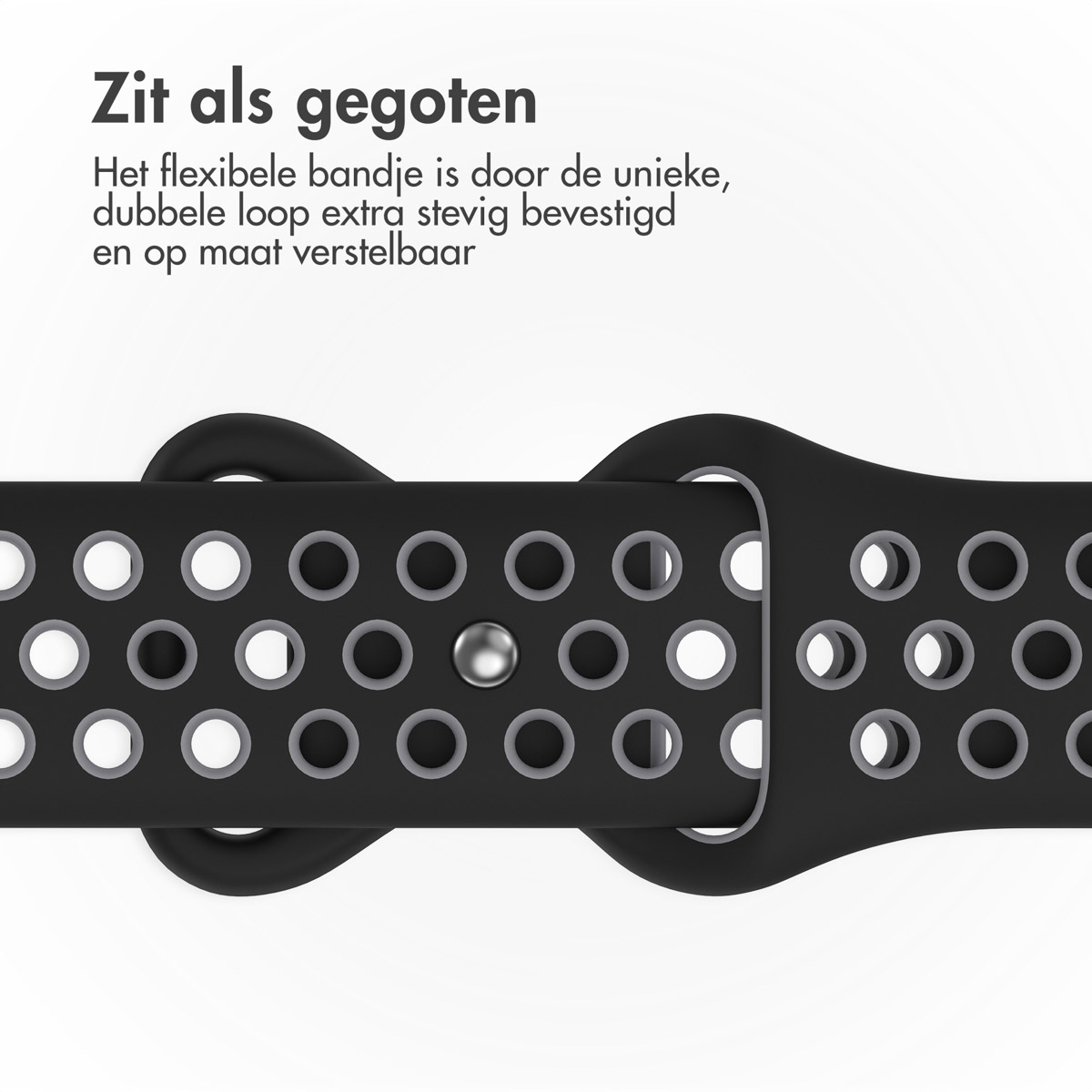 Close-up of a black watch strap with many holes. The strap has a double loop design. A small silver sphere is visible.