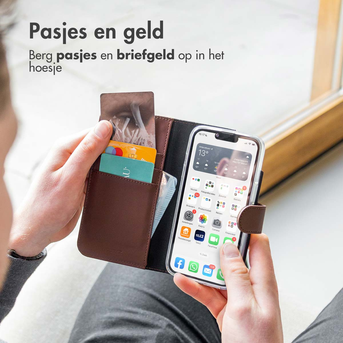 Person holding a phone case with cards and money inside. Shows phone screen.