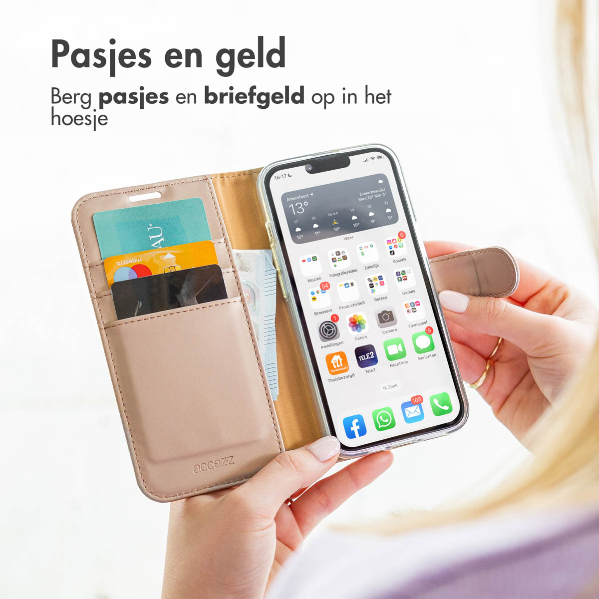 Een persoon houdt een beige telefoonhoesje met pasjes en geld vast in één hand en een smartphone in de andere.