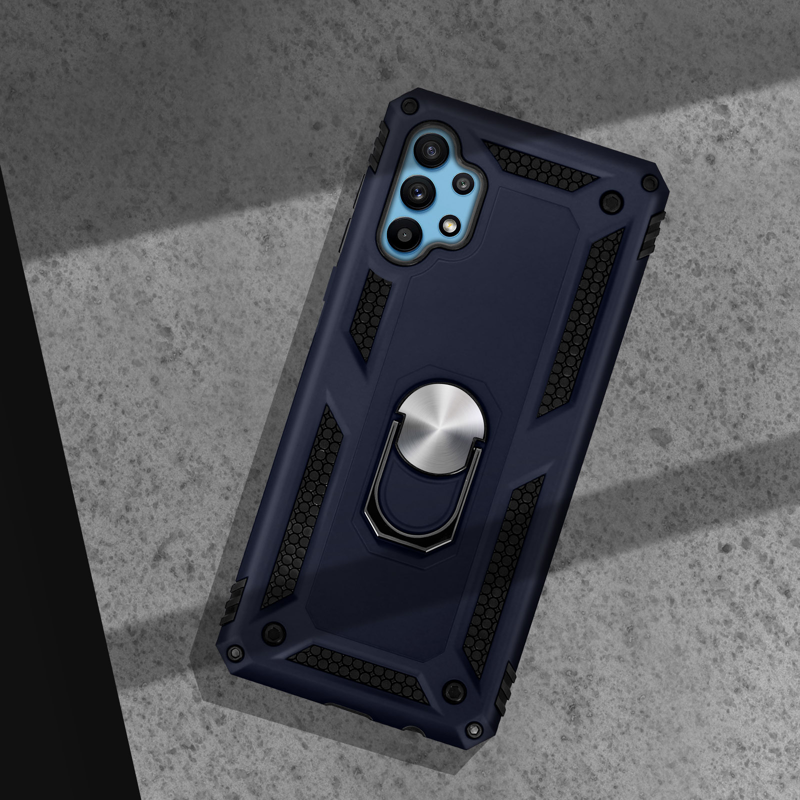 Coque de téléphone bleu foncé avec anneau argenté sur surface béton grise.