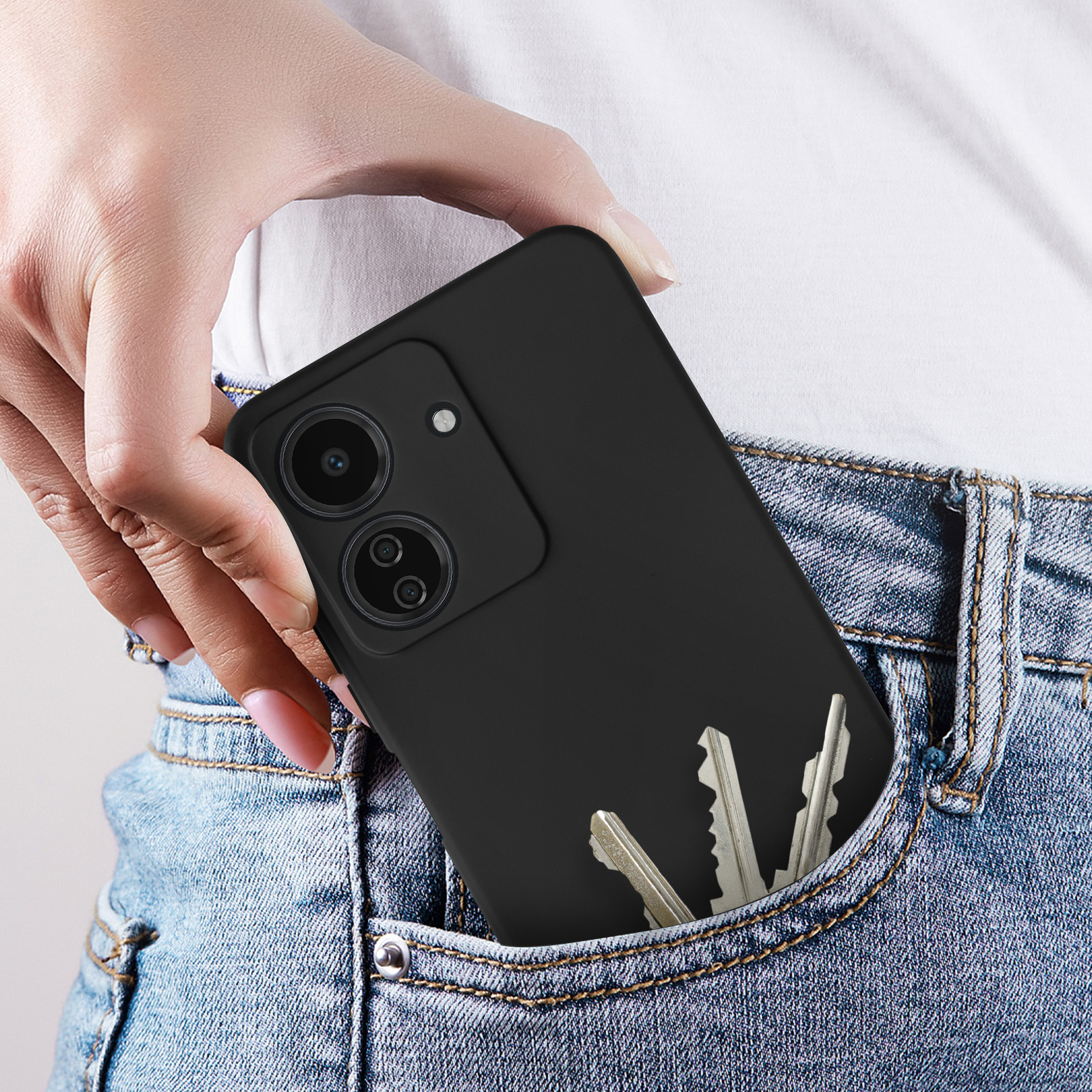 Un telefono nero nella tasca dei jeans, con le chiavi in tasca.