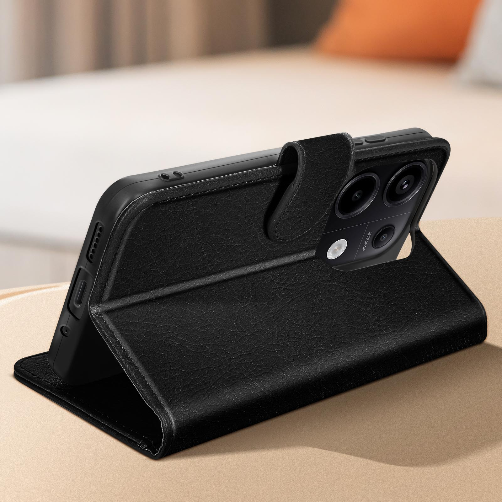 Custodia in pelle nera in posizione aperta. Telefono visibile, su una superficie.