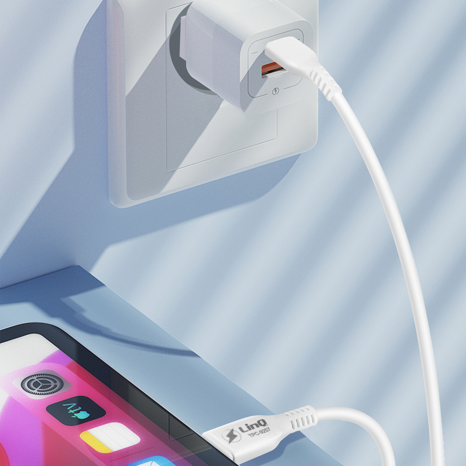 Telefon wird aufgeladen, Kabel an einer Steckdose angeschlossen. Das Telefon zeigt App-Symbole an. Blauer und weißer Hintergrund.