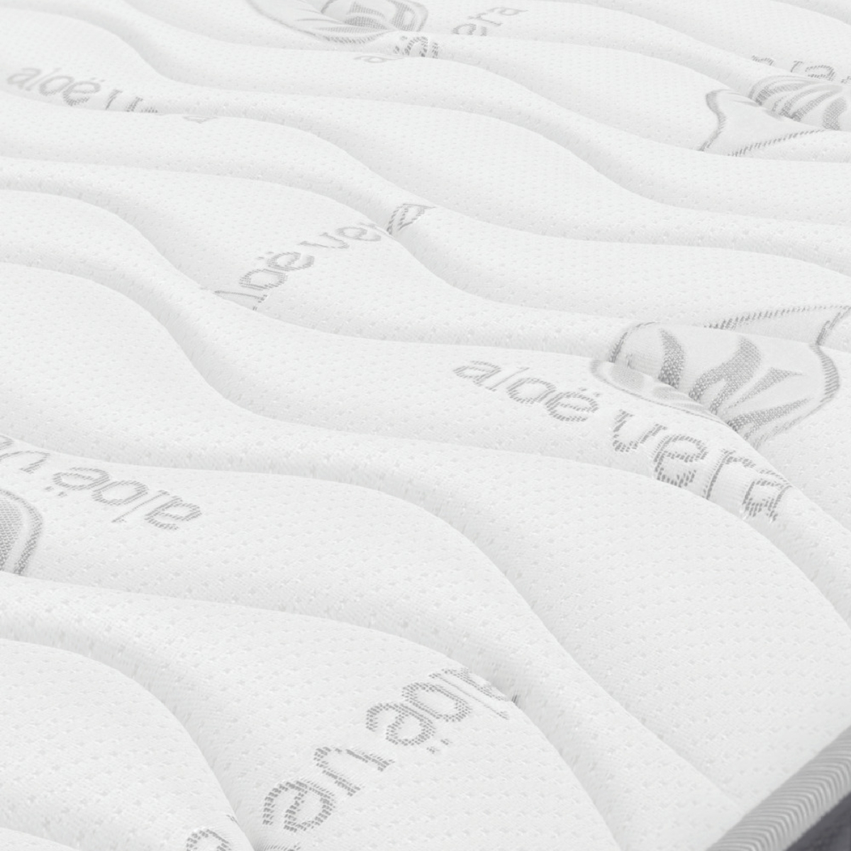 Un colchón blanco con texto 'aloe vera', con líneas onduladas. El fondo es una superficie blanca.