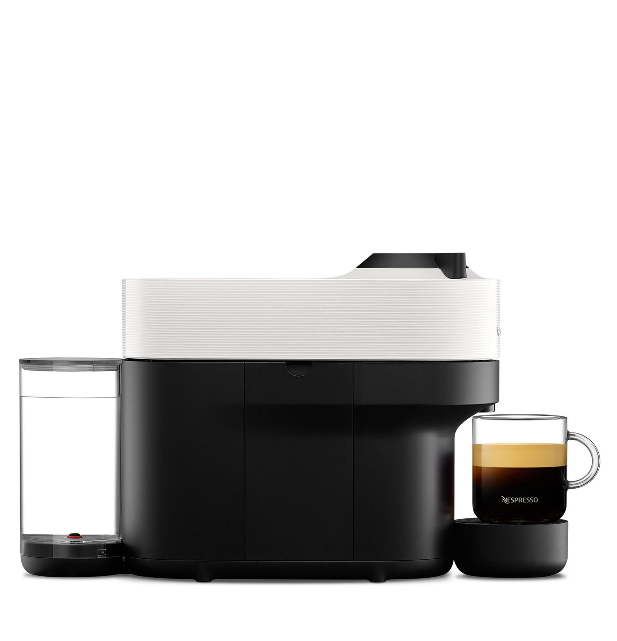 Black and white coffee machine with glass cup of coffee, water tank, and coffee in cup.
