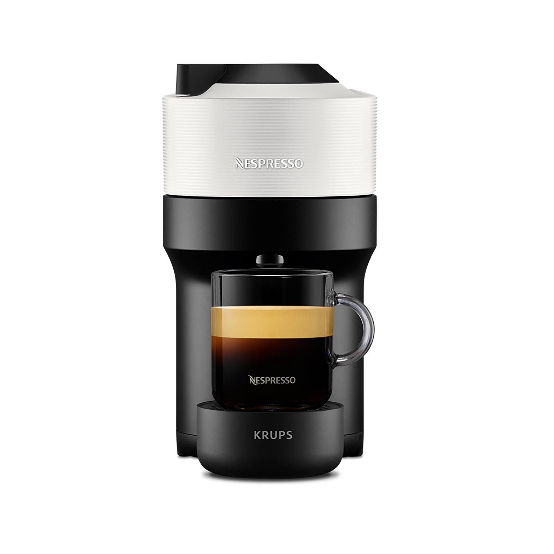 A Nespresso coffee machine with a cup. The machine is black and white, and the cup holds coffee.
