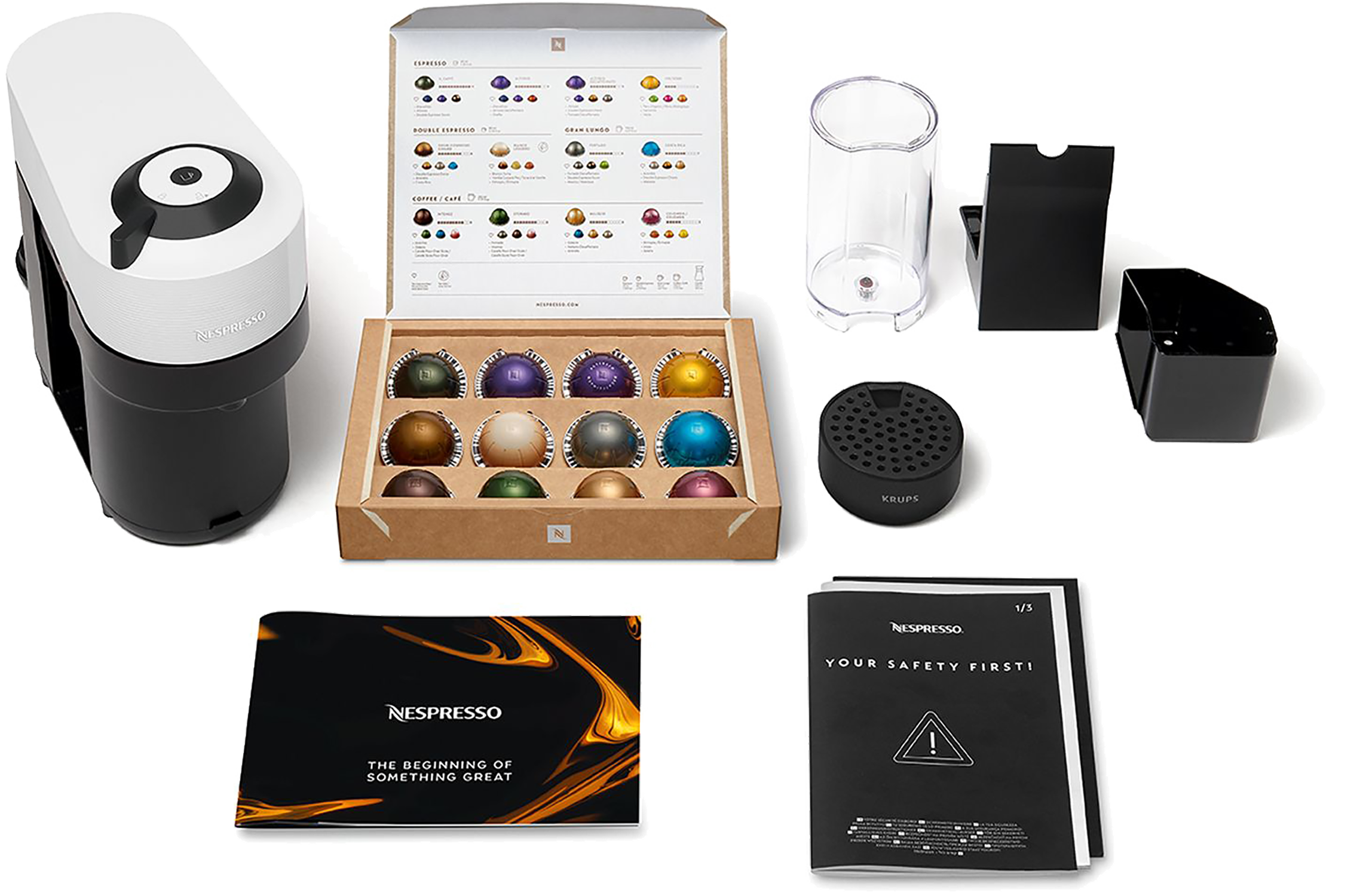 Nespresso coffee machine and accessories, including capsules and instructions.
