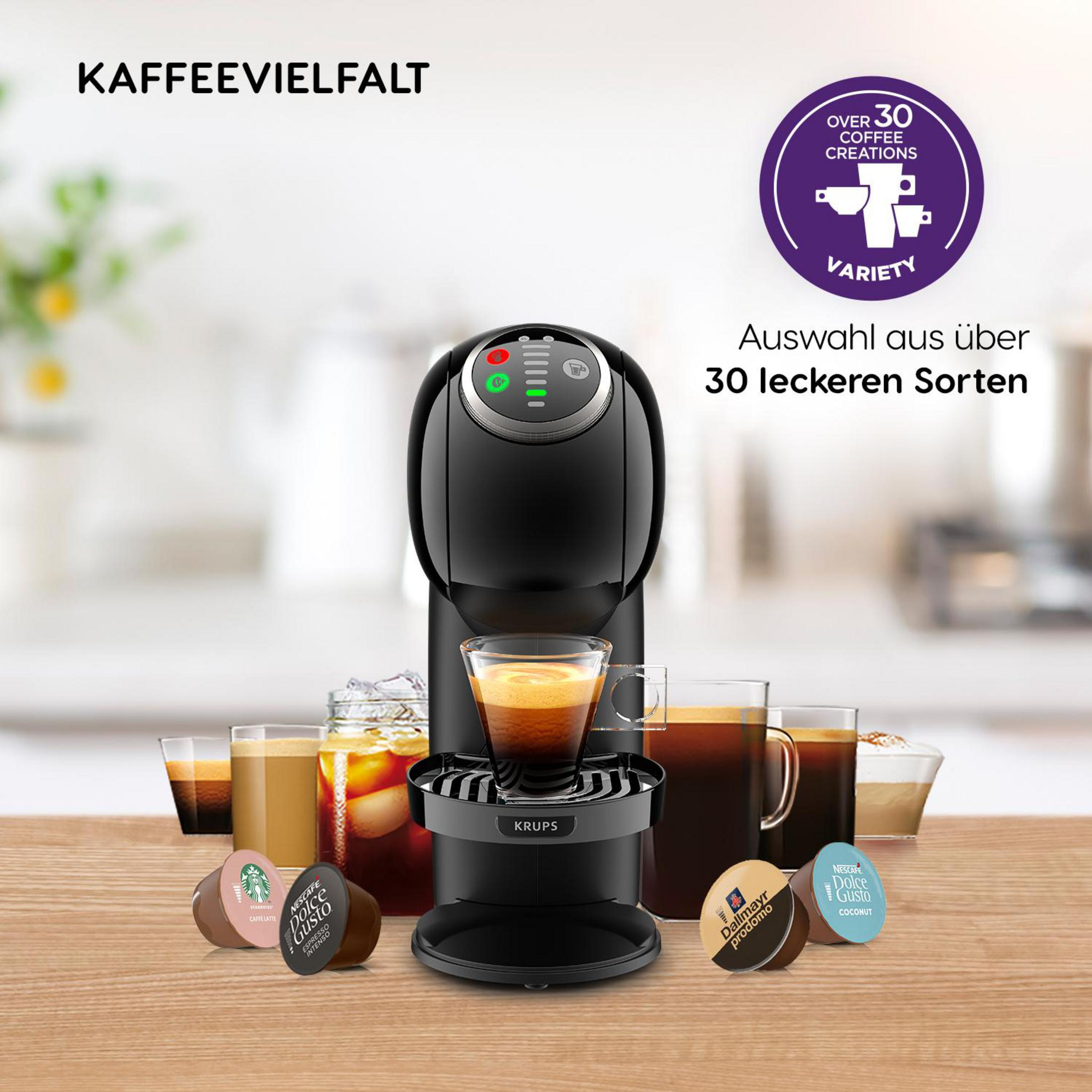 Ekspres do kawy z kapsułkami i filiżankami. Tło: różne filiżanki do kawy.