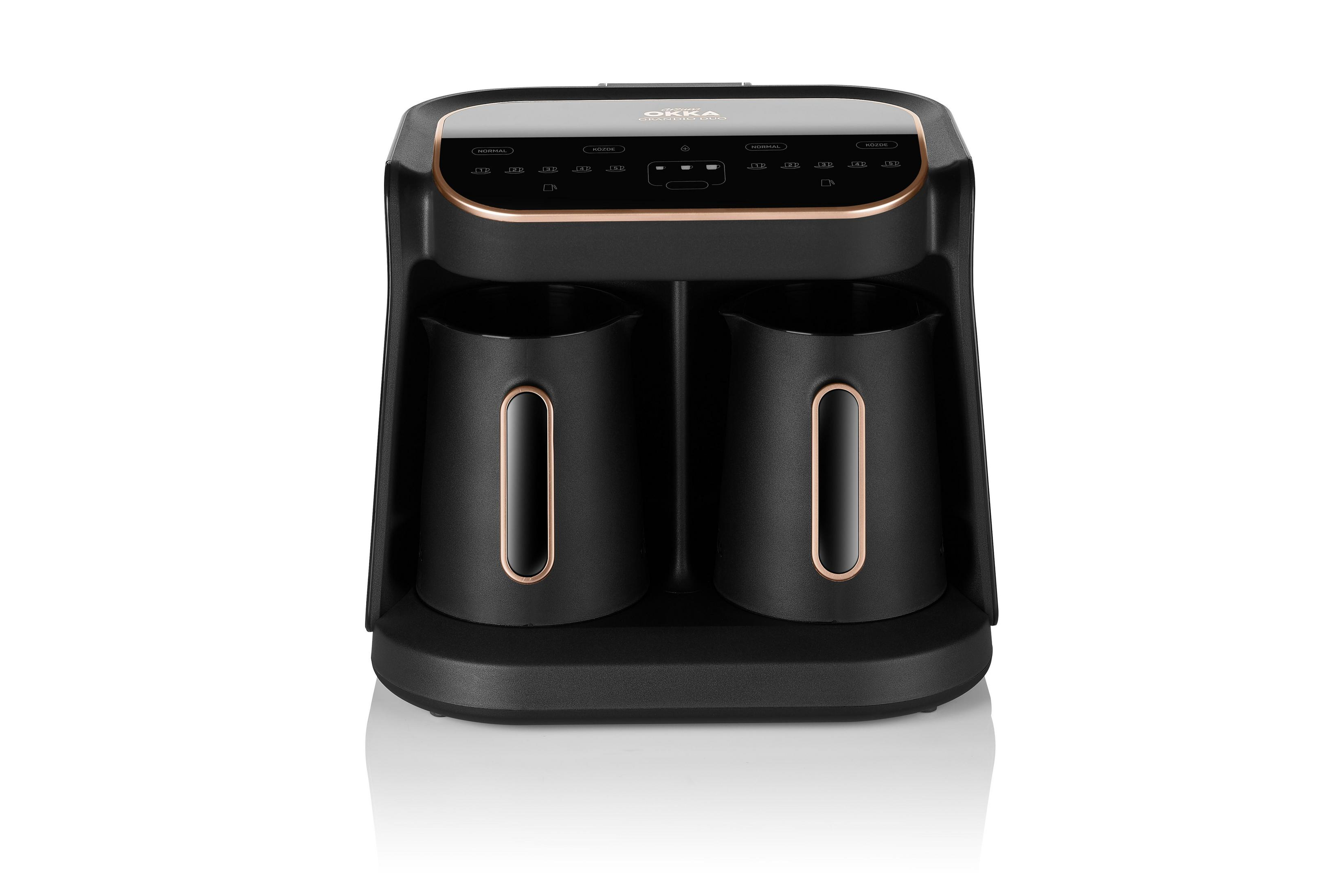 Czarny ekspres do kawy z dwoma wylewami i złotymi akcentami na białym tle.