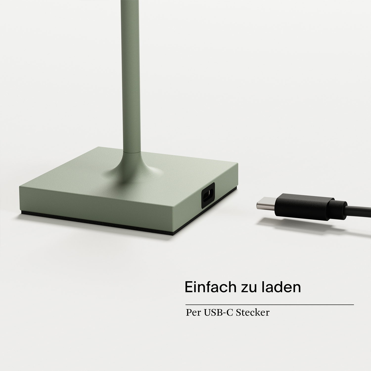 Ein grüner Lampensockel mit USB-C-Anschluss und schwarzem Kabel auf weißem Hintergrund.
