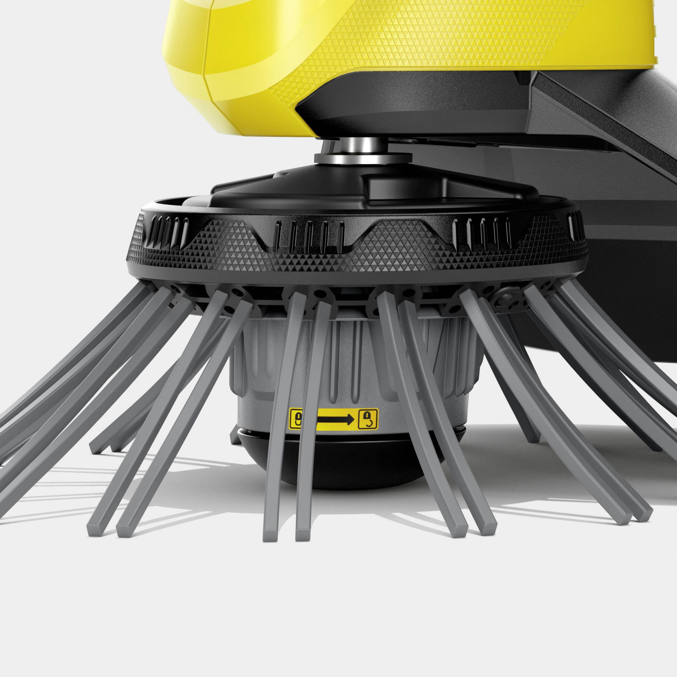 Zbliżenie obrotowej szczotki żółto-czarnego robota sprzątającego.
