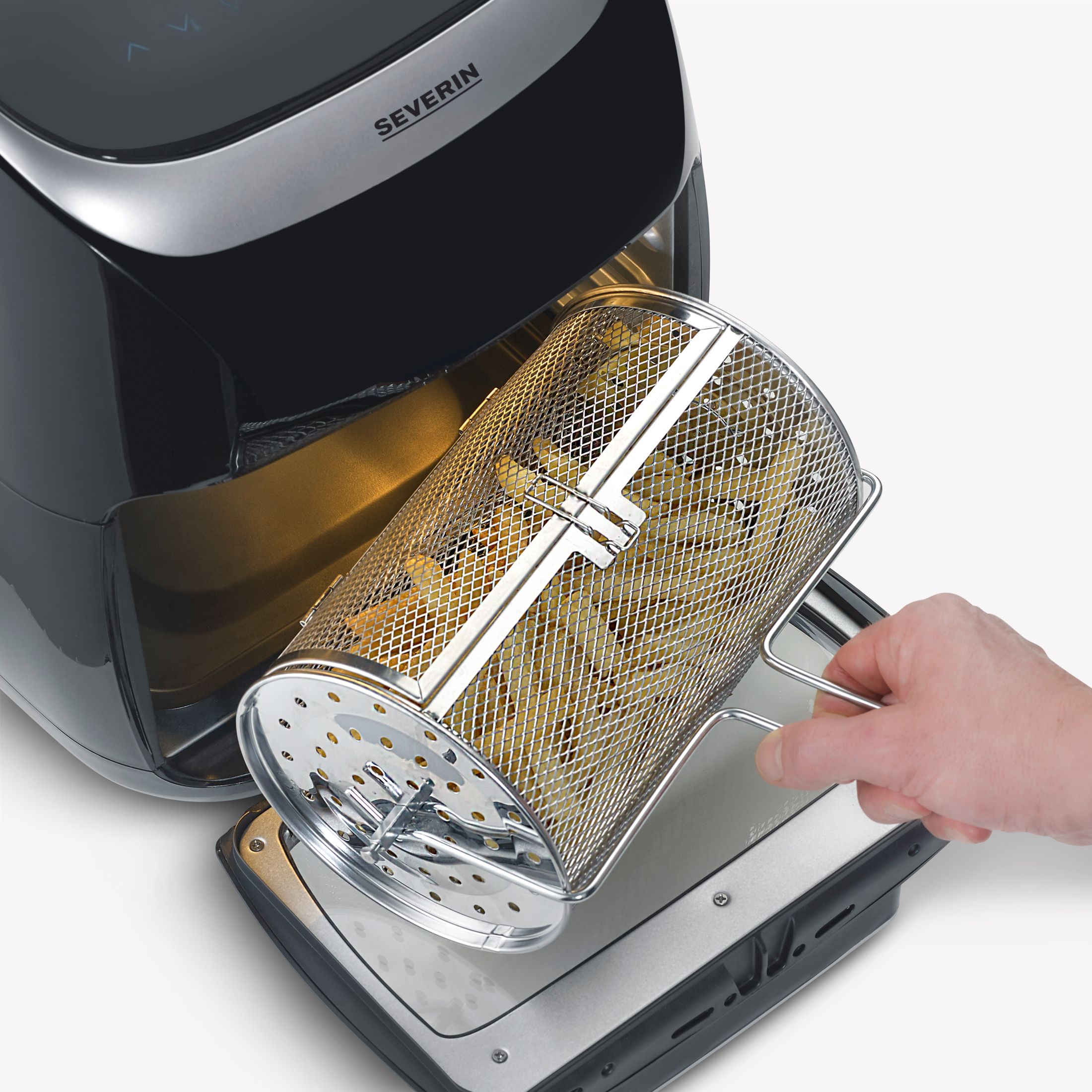 Osoba trzymająca kosz frytek z frytownicy powietrznej. Tło jest białe.