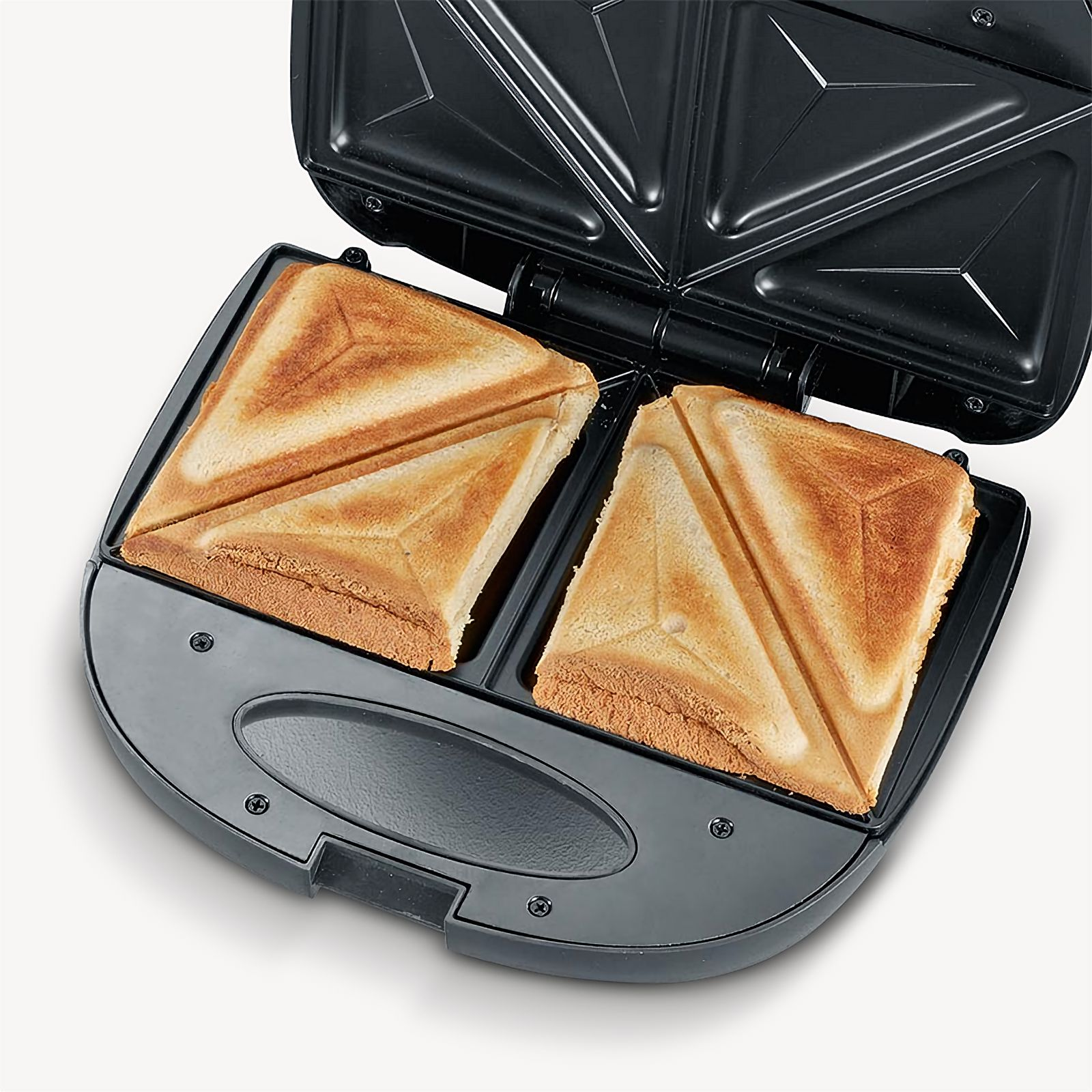 A black sandwich maker with two toasted sandwiches inside, on white.