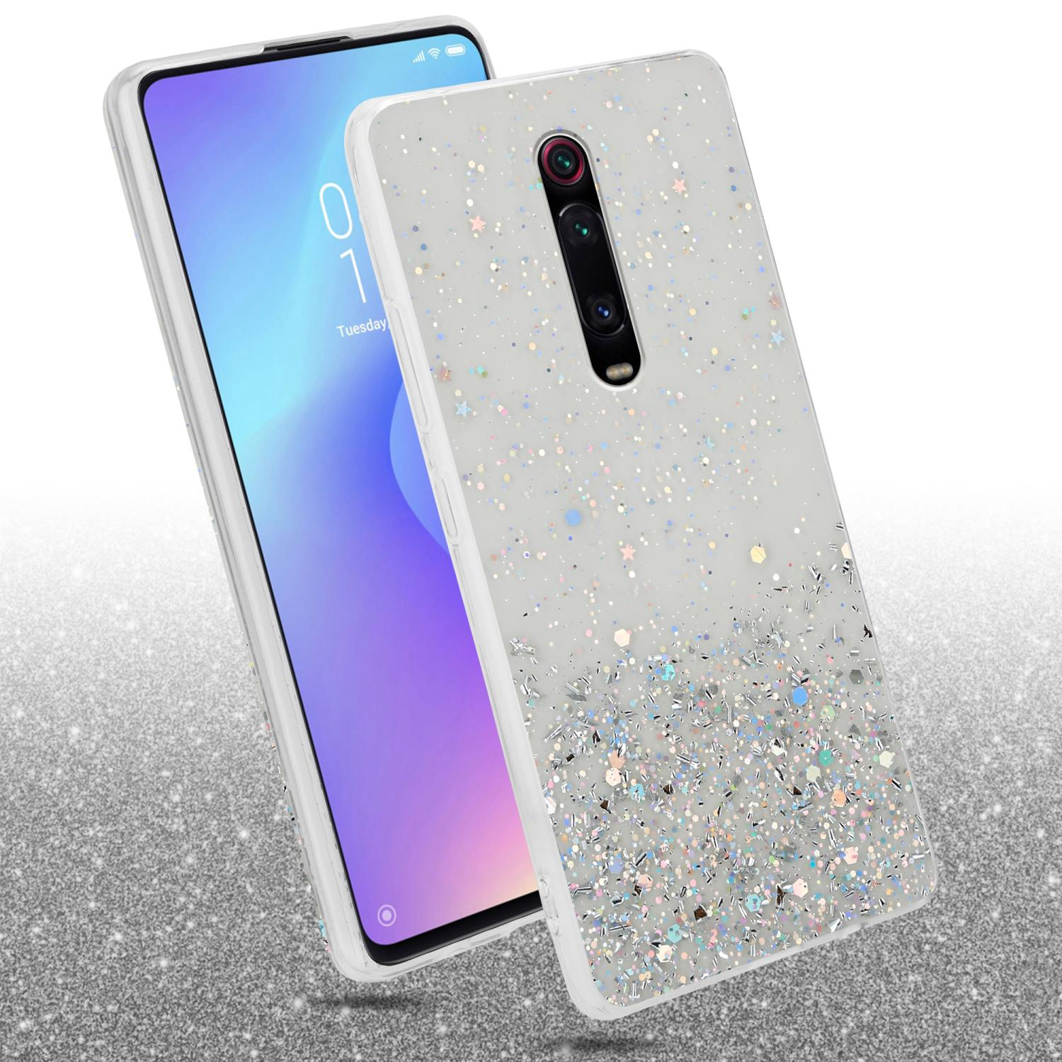 Custodia per telefono con motivo glitterato. Il telefono è bianco con una fotocamera a doppio obiettivo.