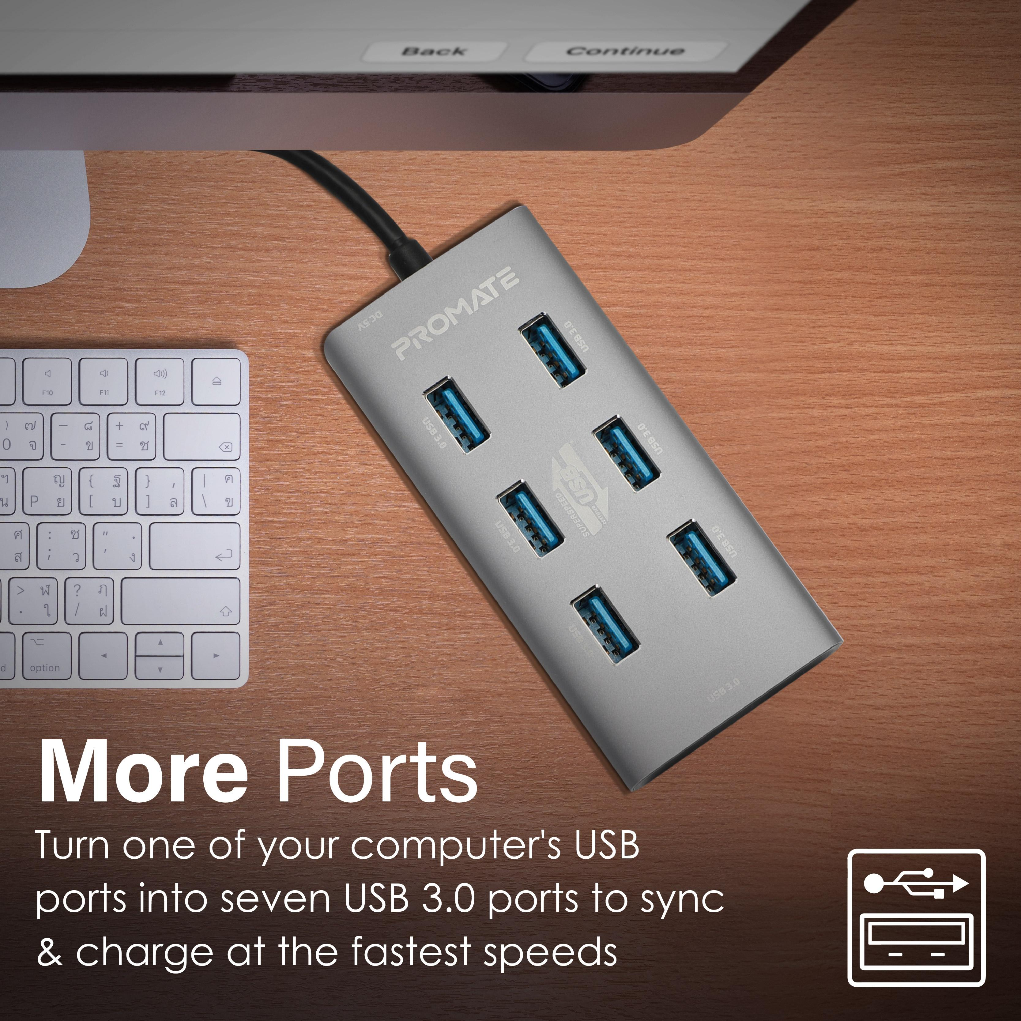 Concentrador USB plateado con siete puertos y texto 'More Ports'.