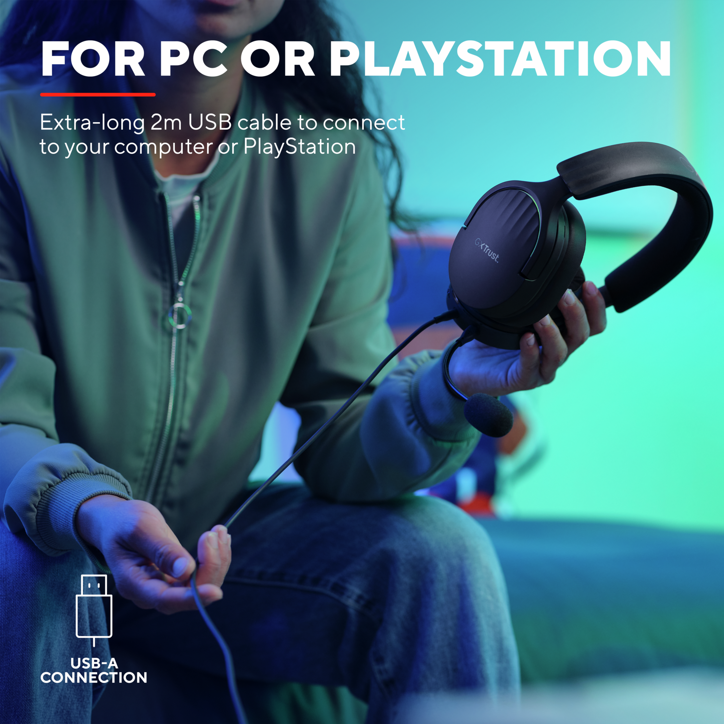 Person holding a headset with a microphone, cable connected to a USB-A connection.