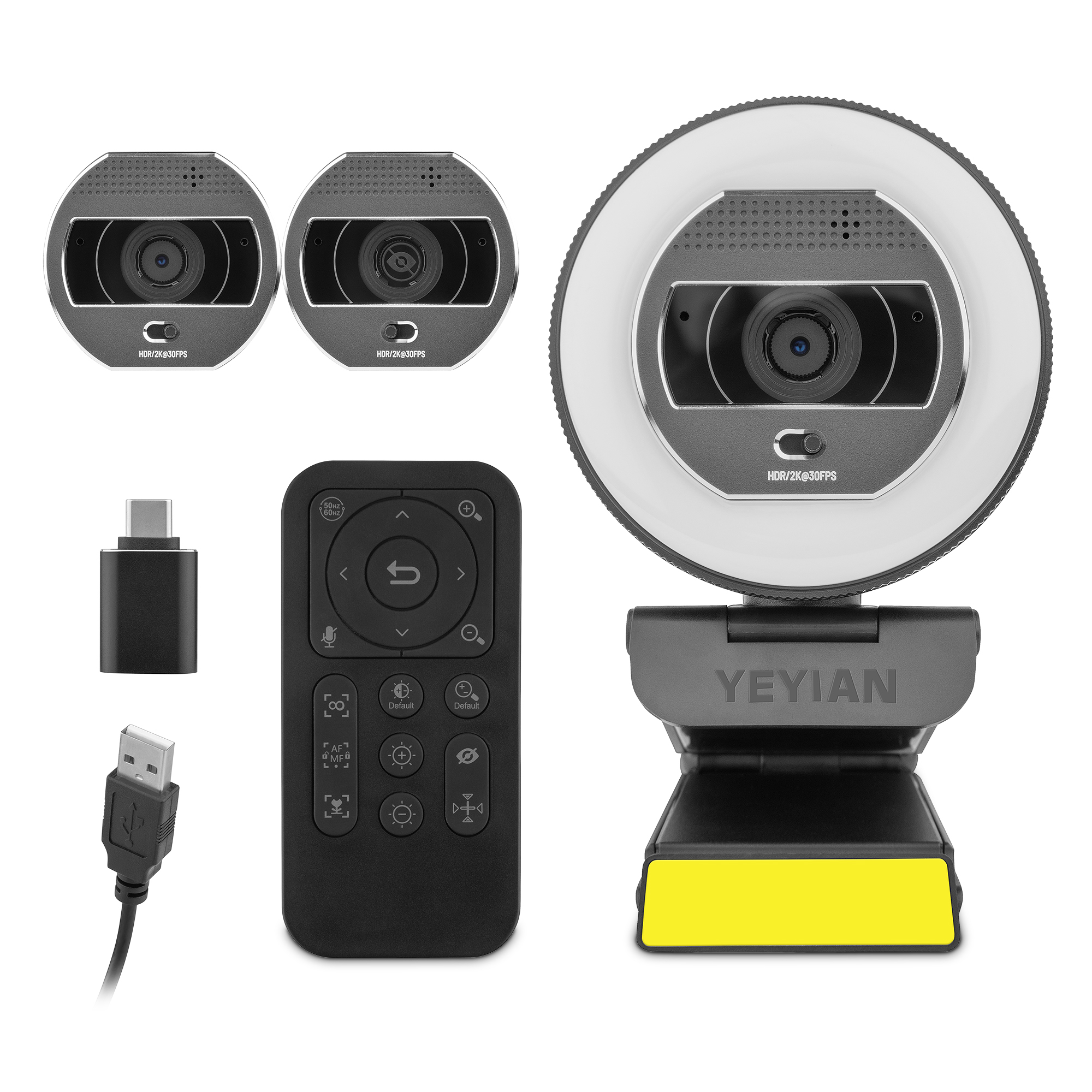 Webcam con una luce ad anello e due fotocamere aggiuntive. Sono inclusi un telecomando e un cavo USB. Tutto su sfondo bianco.