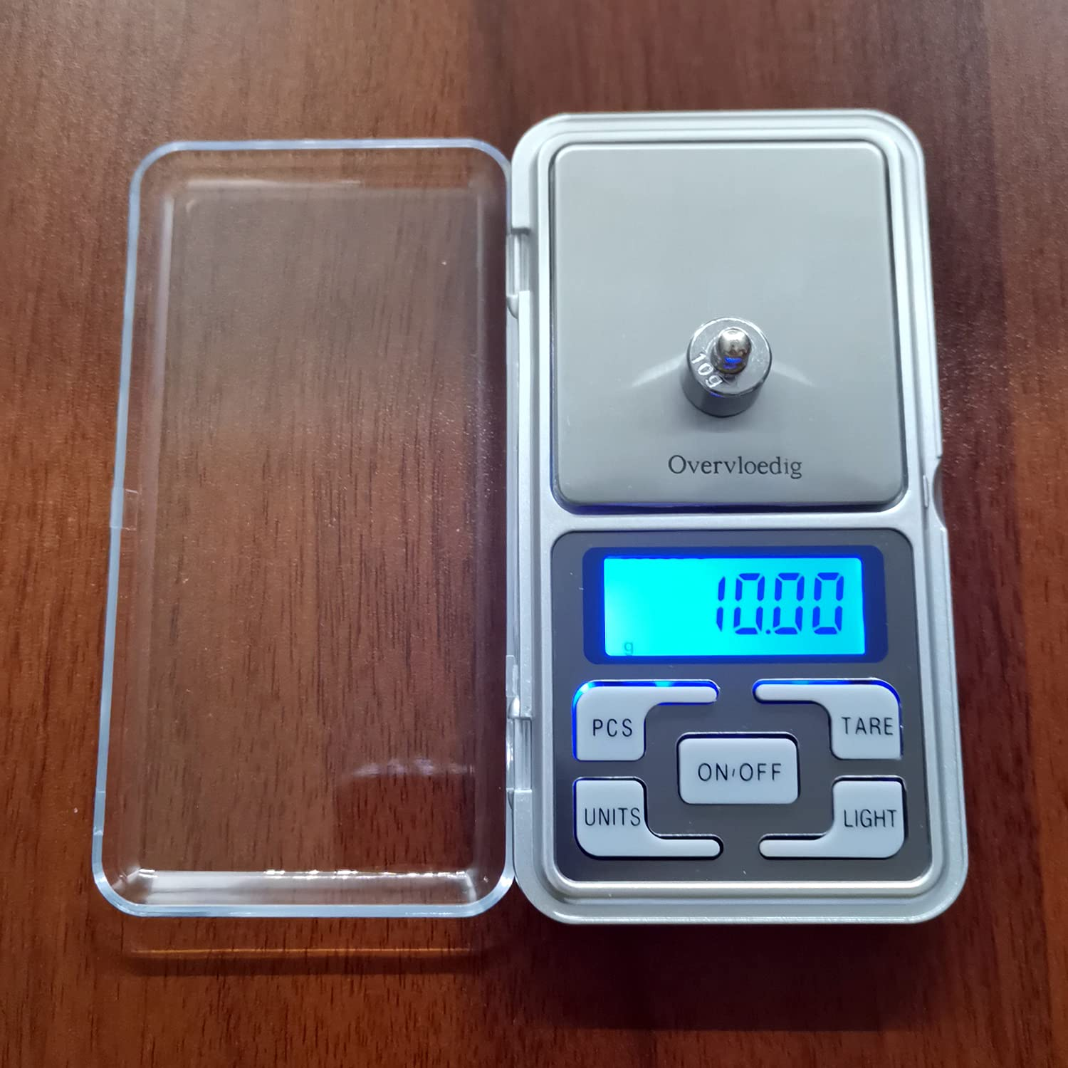 Digitale Waage mit 10,00 Anzeige, einem Gewicht und einer offenen, transparenten Kunststoffabdeckung.