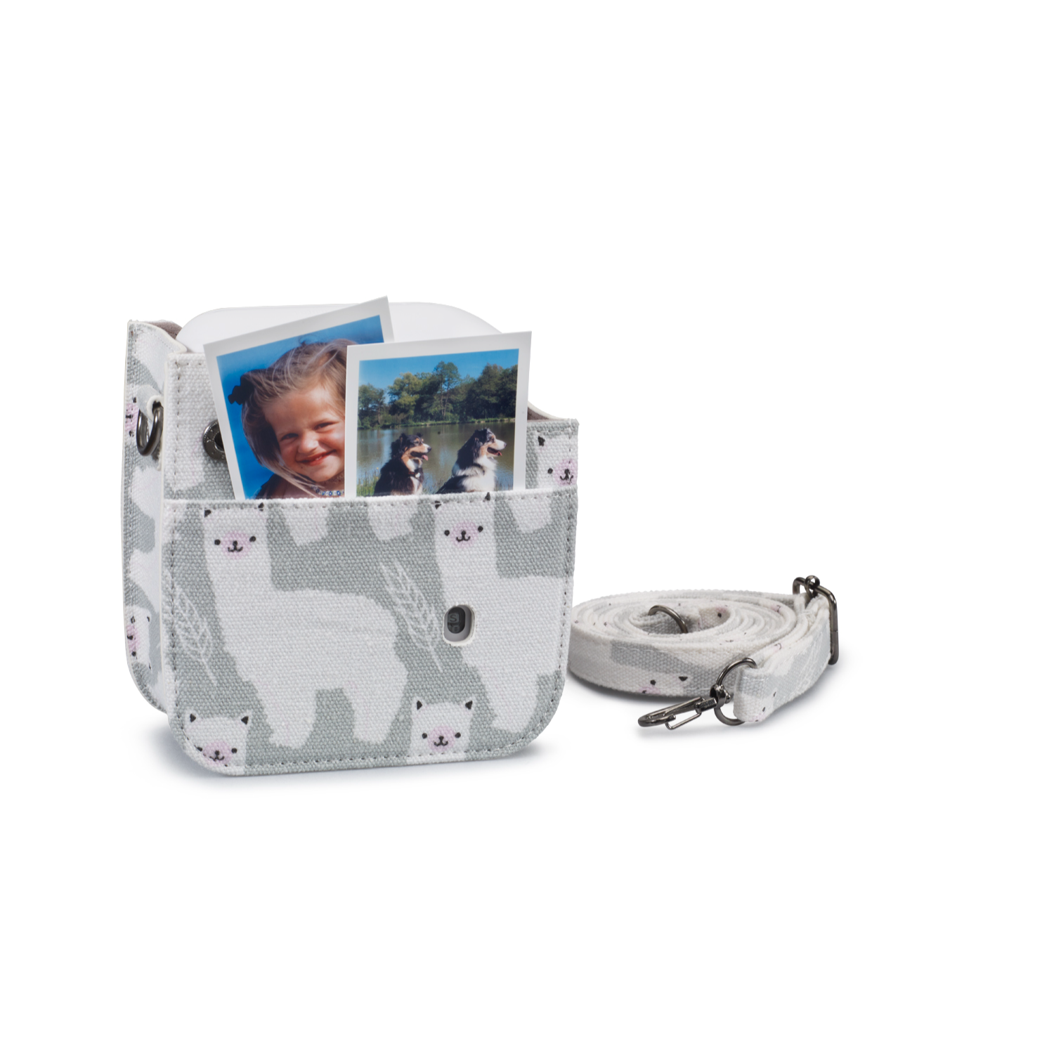 Graue Canvas-Tasche mit weißem Lama-Muster, hält zwei Fotos. Gurt rechts.