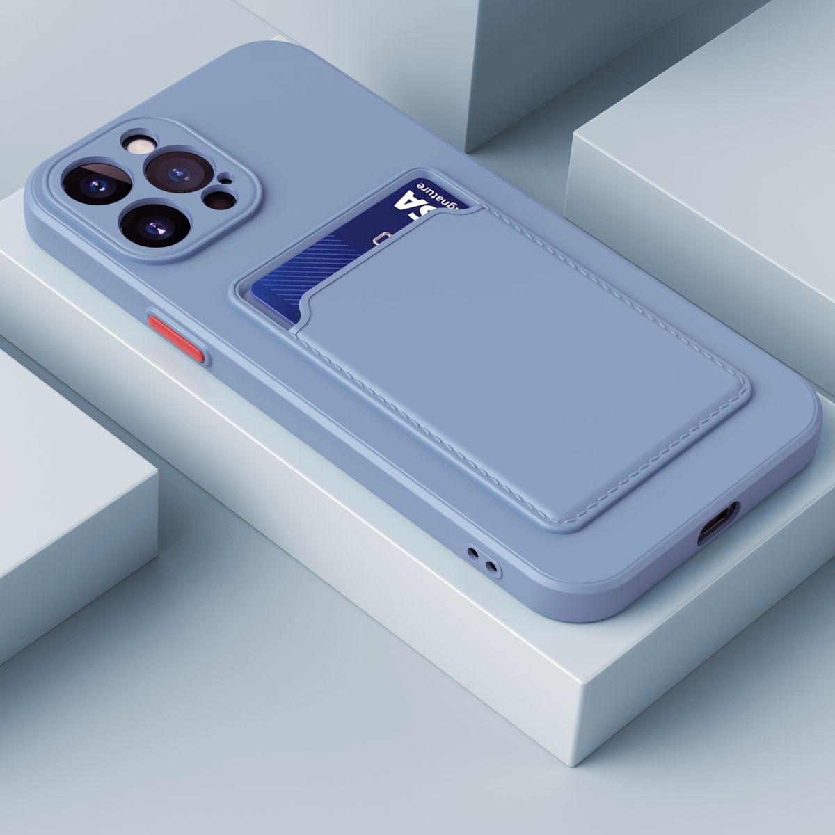 Eine blaue Handyhülle mit Kartenfach und einem Telefon darin. Die Hülle liegt auf einer weißen Oberfläche.