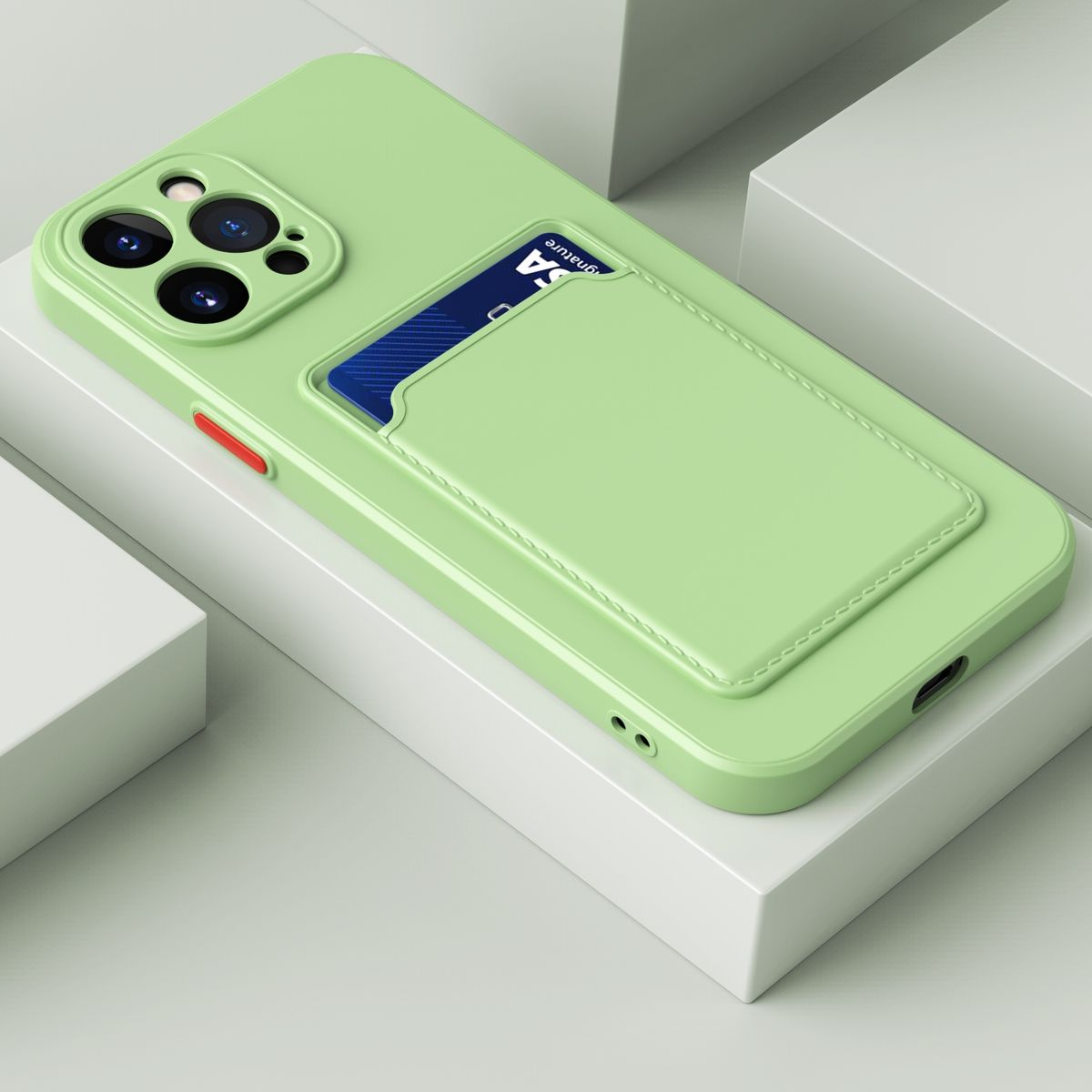 Grüne Handyhülle mit Kartenfach. Telefon auf weißer Fläche.