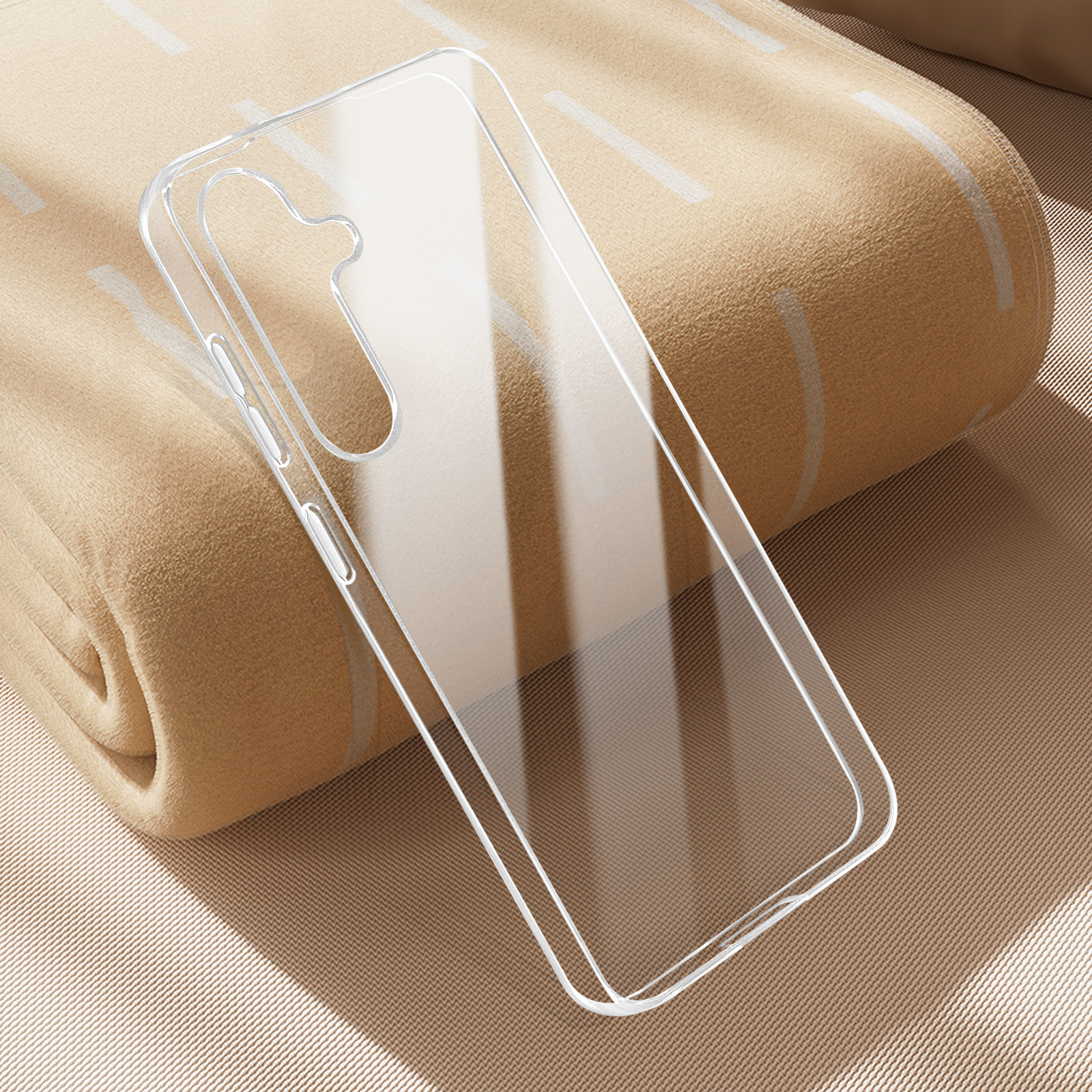 Custodia trasparente per telefono su una coperta beige. Sembra essere una cover protettiva.