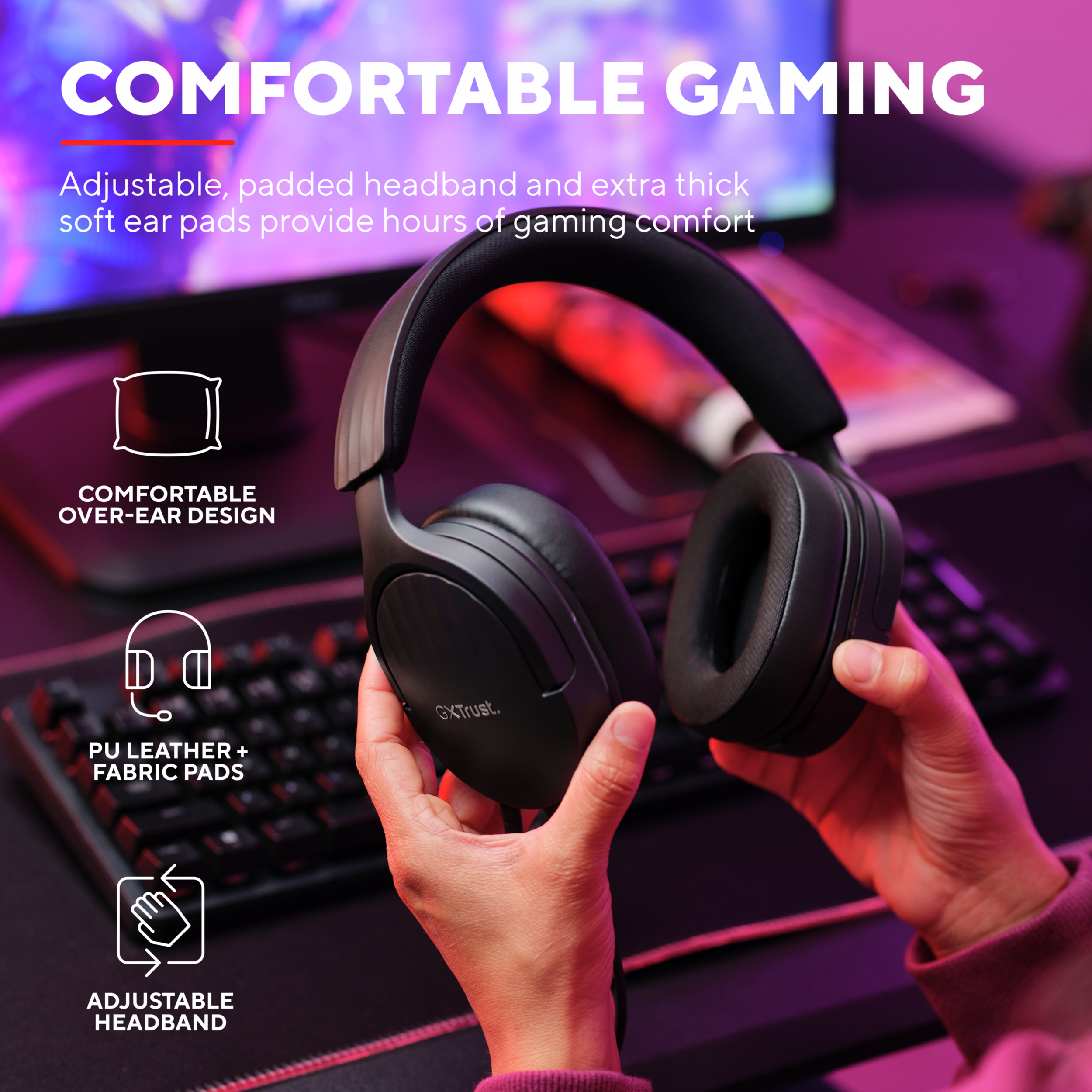 Black gaming headphones with a microphone, held in hands.