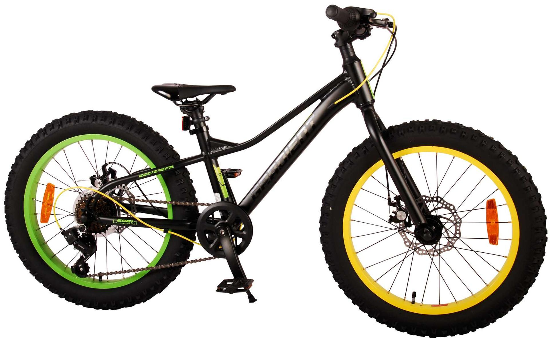 Ein schwarz-gelbes Fatbike mit grünen Felgen, von der Seite betrachtet.