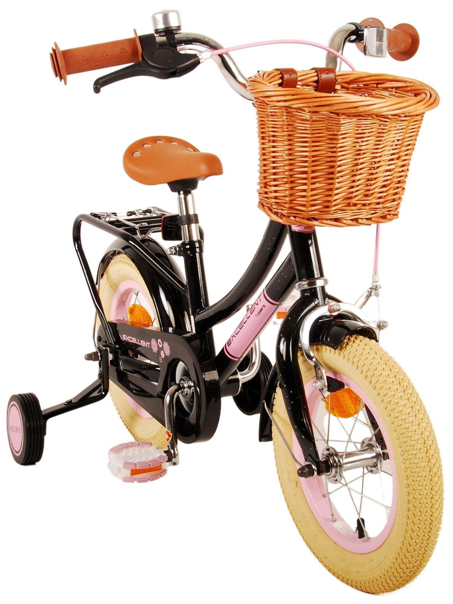 Schwarzes und rosa Kinderfahrrad mit Weidenkorb und Stützrädern. Brauner Sitz und rosa Reifen.