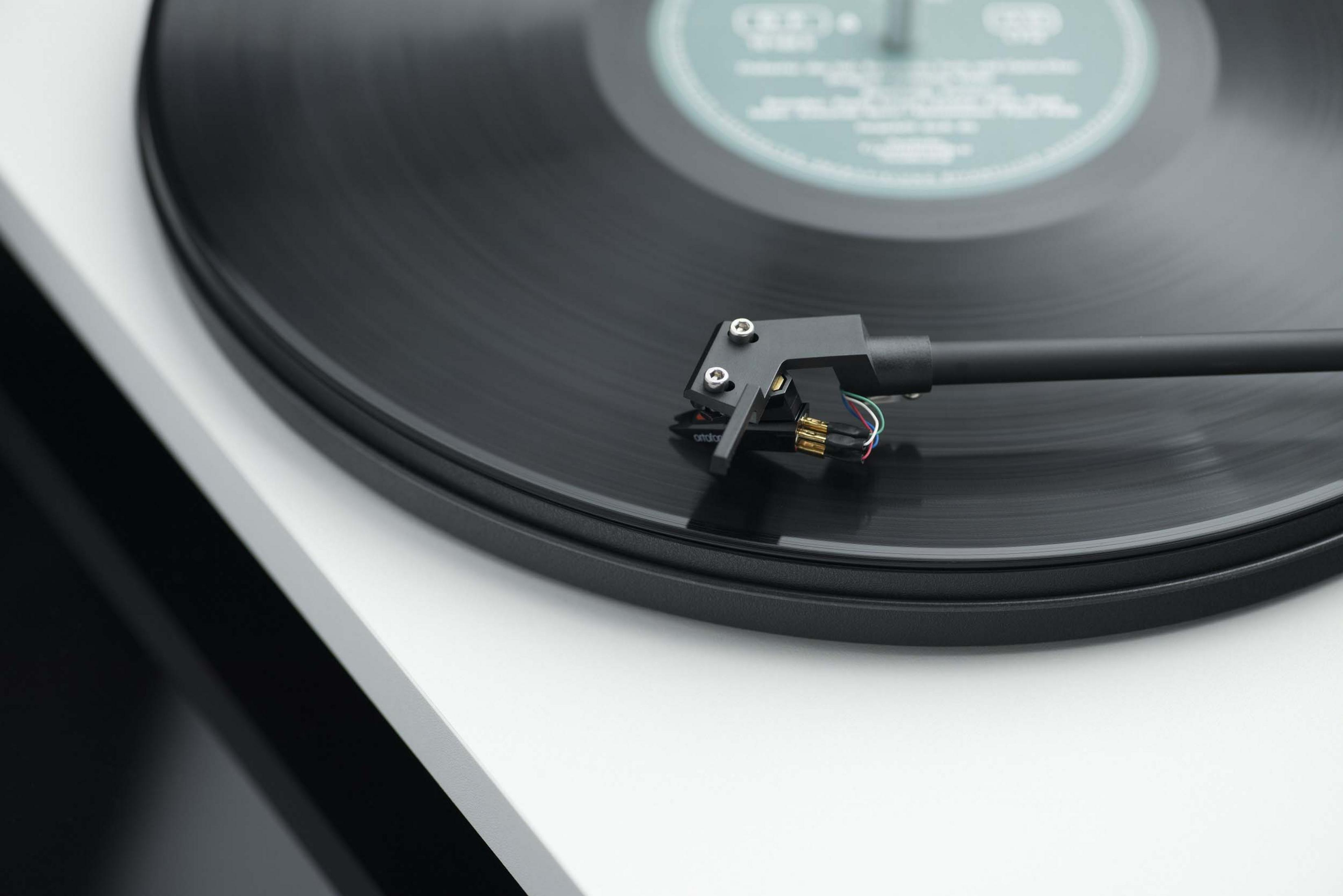Giradischi con disco nero, braccio nero. Primo piano dello stilo sul disco in vinile.