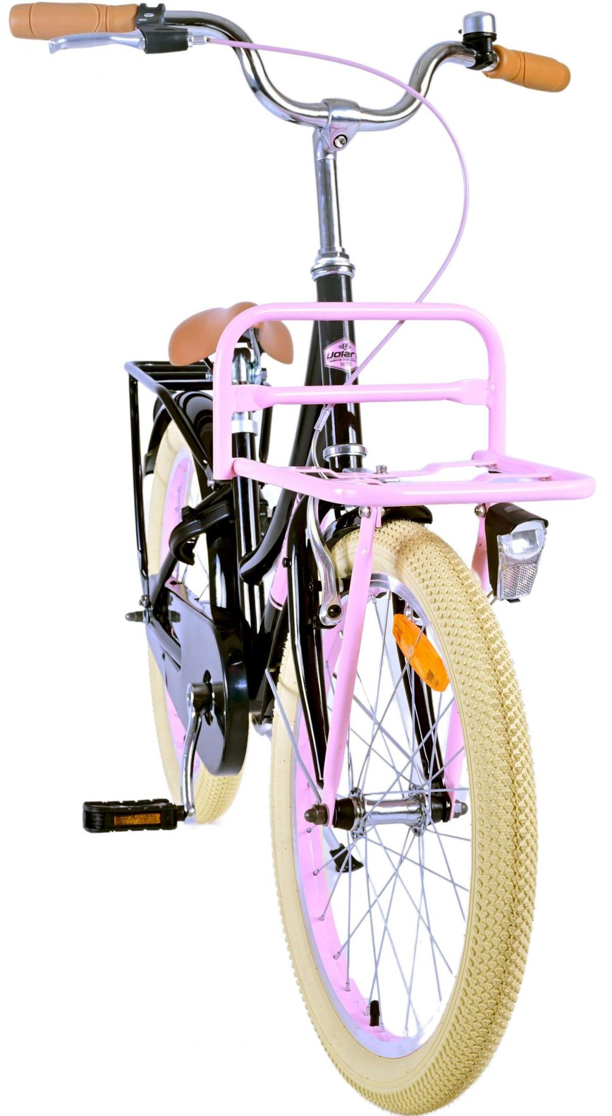 Rosa Fahrrad mit Frontkorb und beigen Reifen. Der Rahmen ist schwarz und rosa.