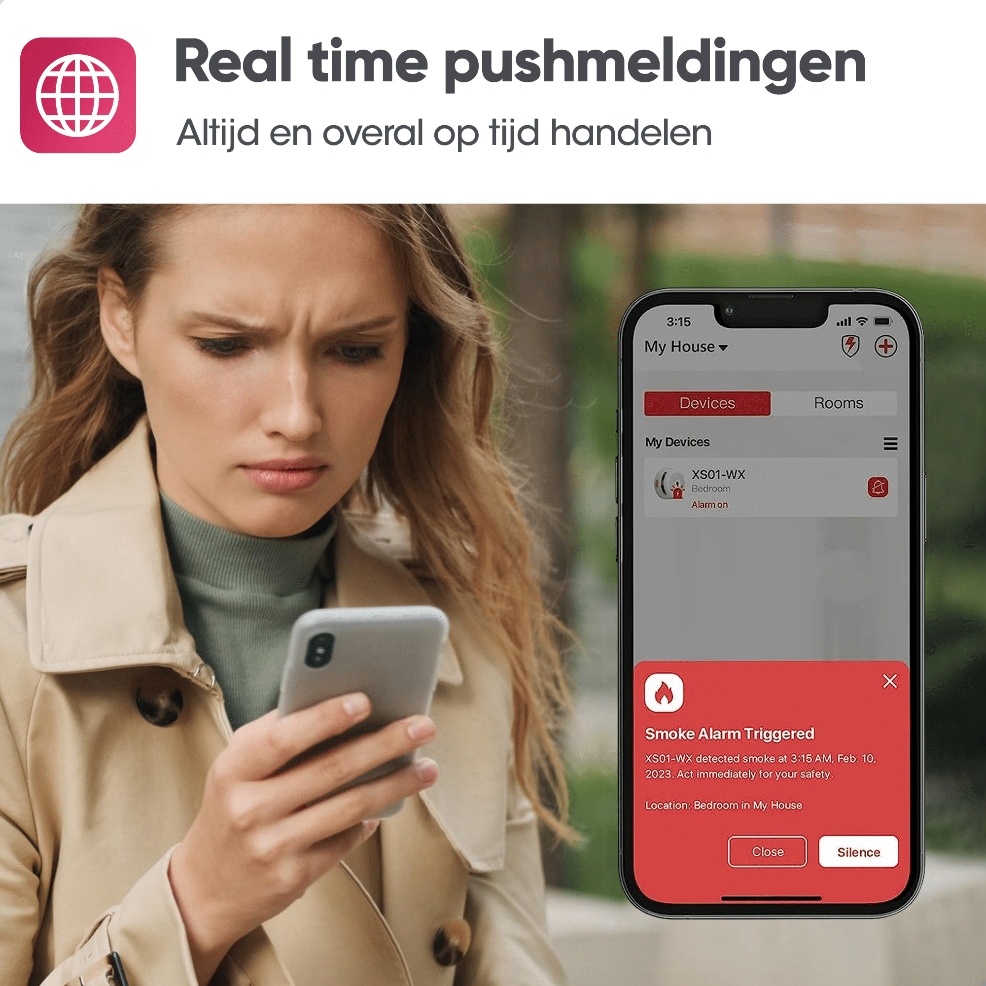 Frau schaut auf ein Telefon mit einem Rauchmelder-Alarm.