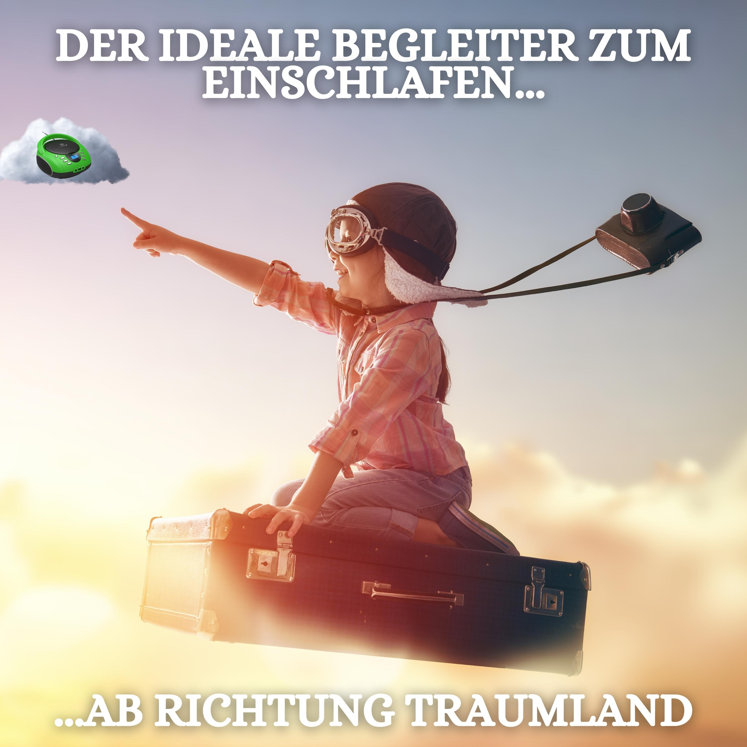 Kind auf Koffer, zeigt auf grünes Objekt im Himmel.