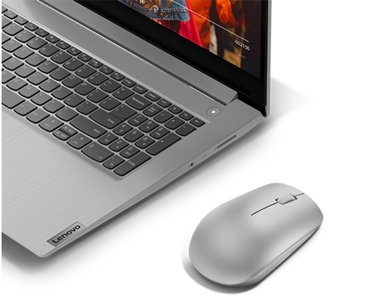 Laptop and mouse; laptop is open, silver, mouse is silver.