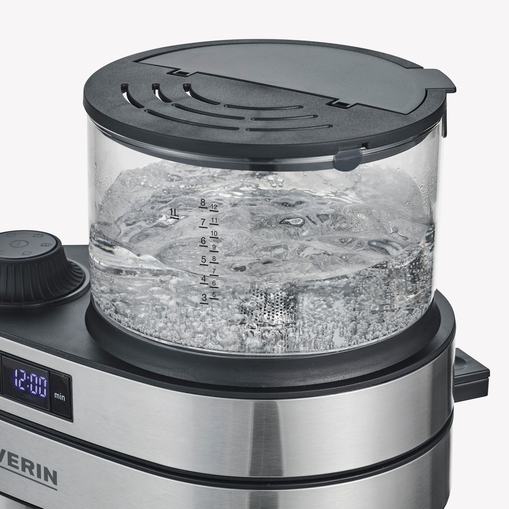 A silver and black water boiler with a glass container. Water is boiling inside.